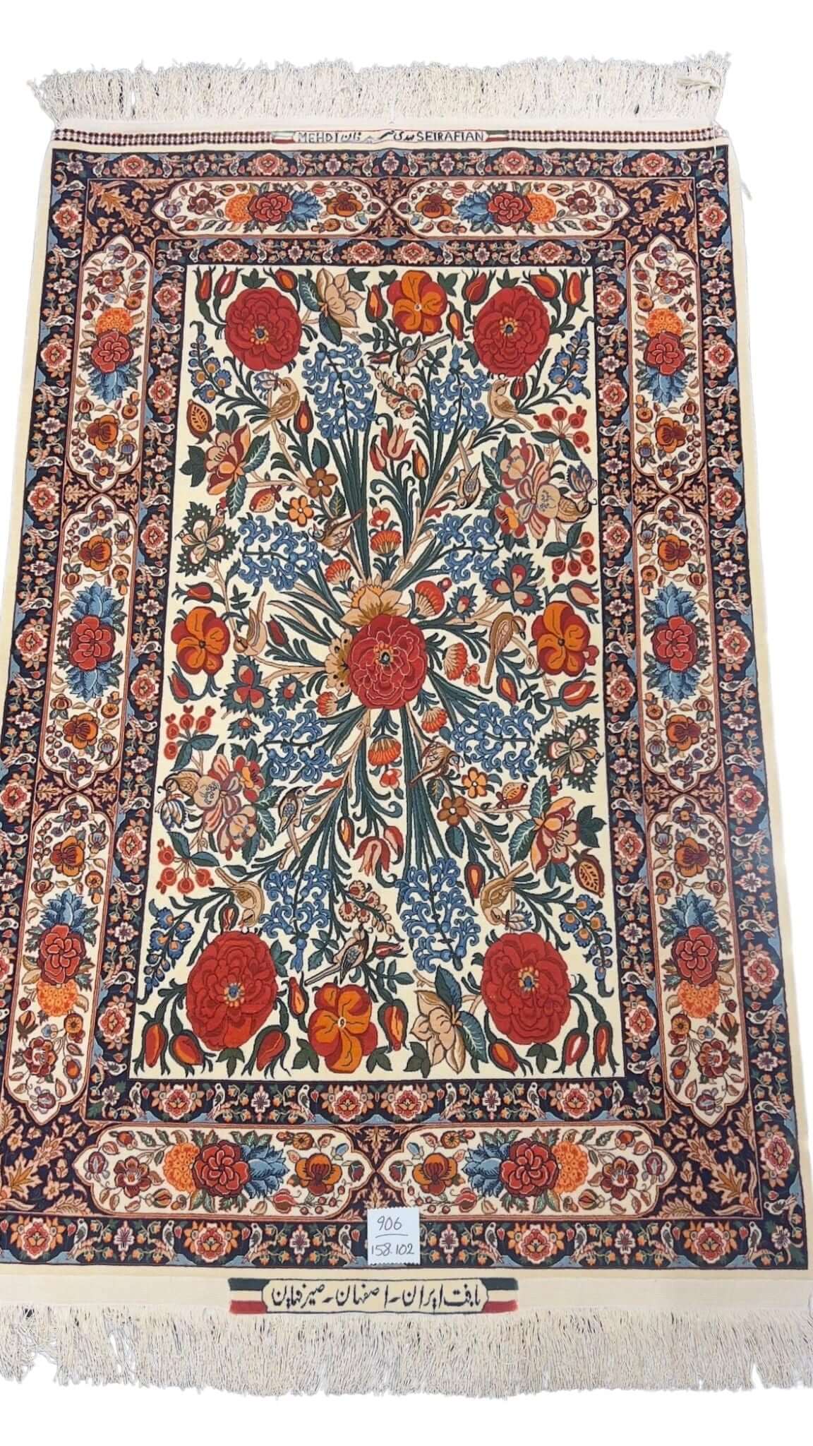 Hand-knotted Persian floral rug by Mehdie Seirafian featuring red roses and intricate borders.
