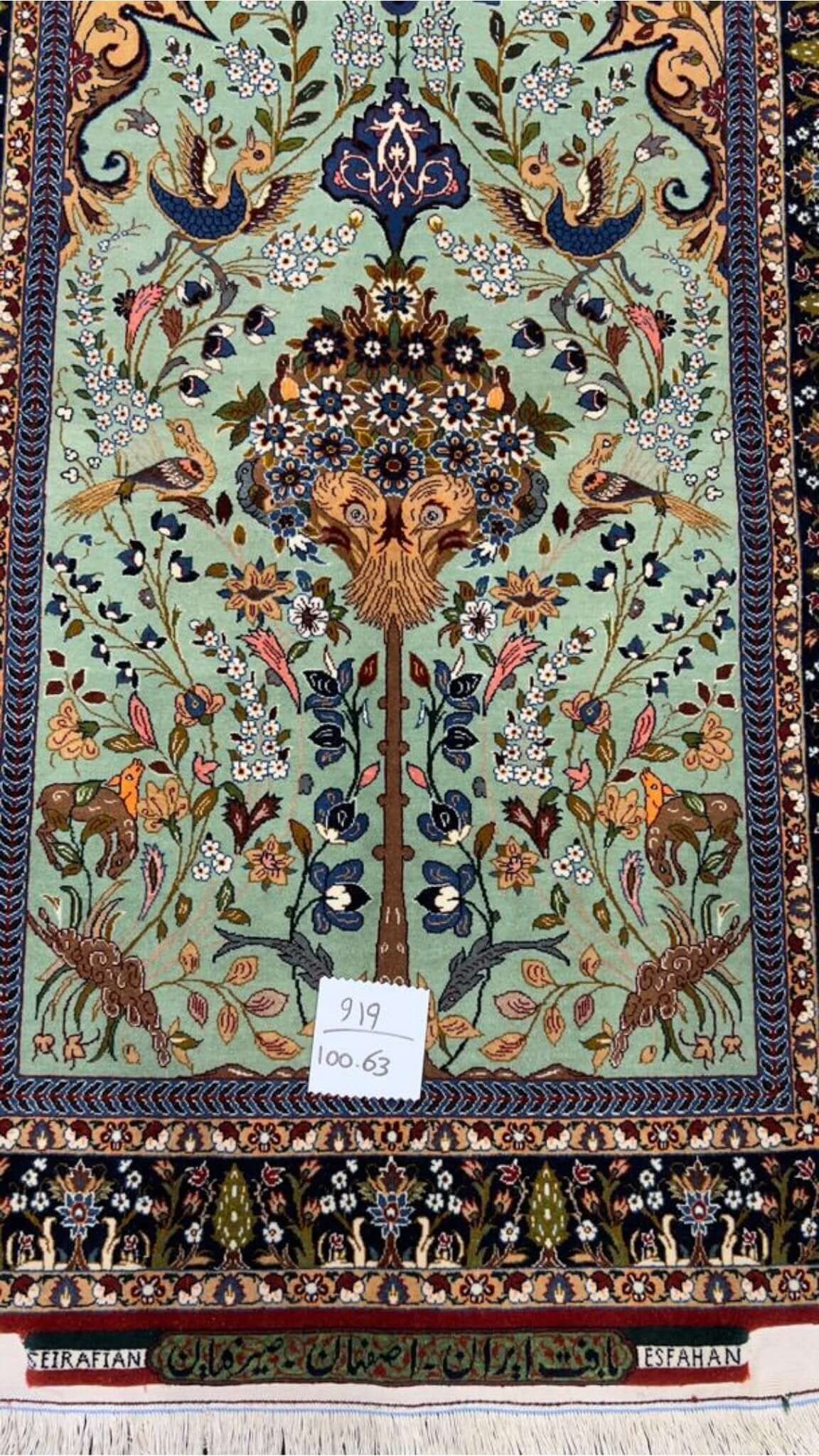 Luxurious Isfahan rug with floral patterns, animals, and birds in vibrant natural dyes.
