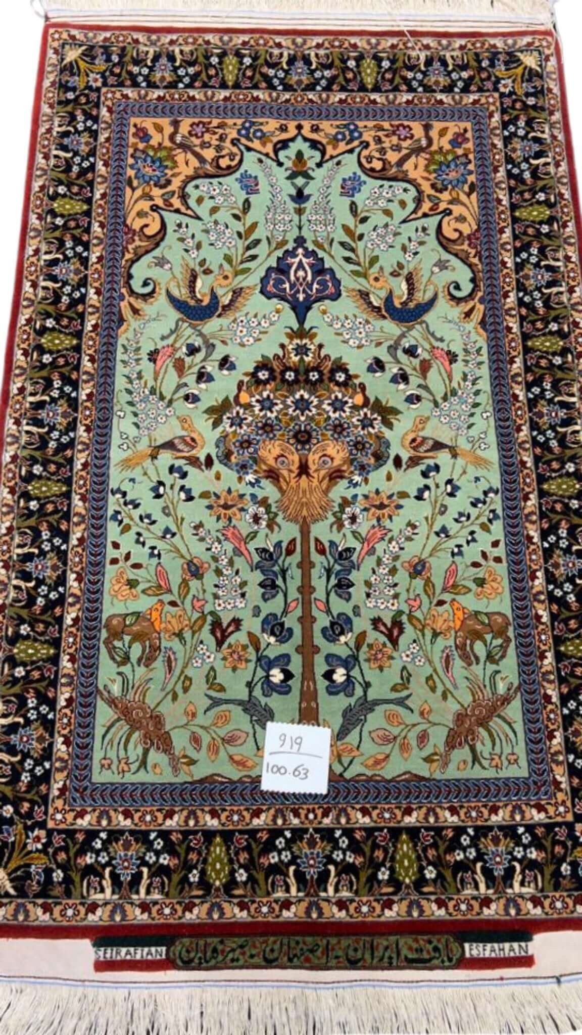 Hand-knotted Persian rug by Seirafian featuring a "Tree of Life" design on a turquoise background.
