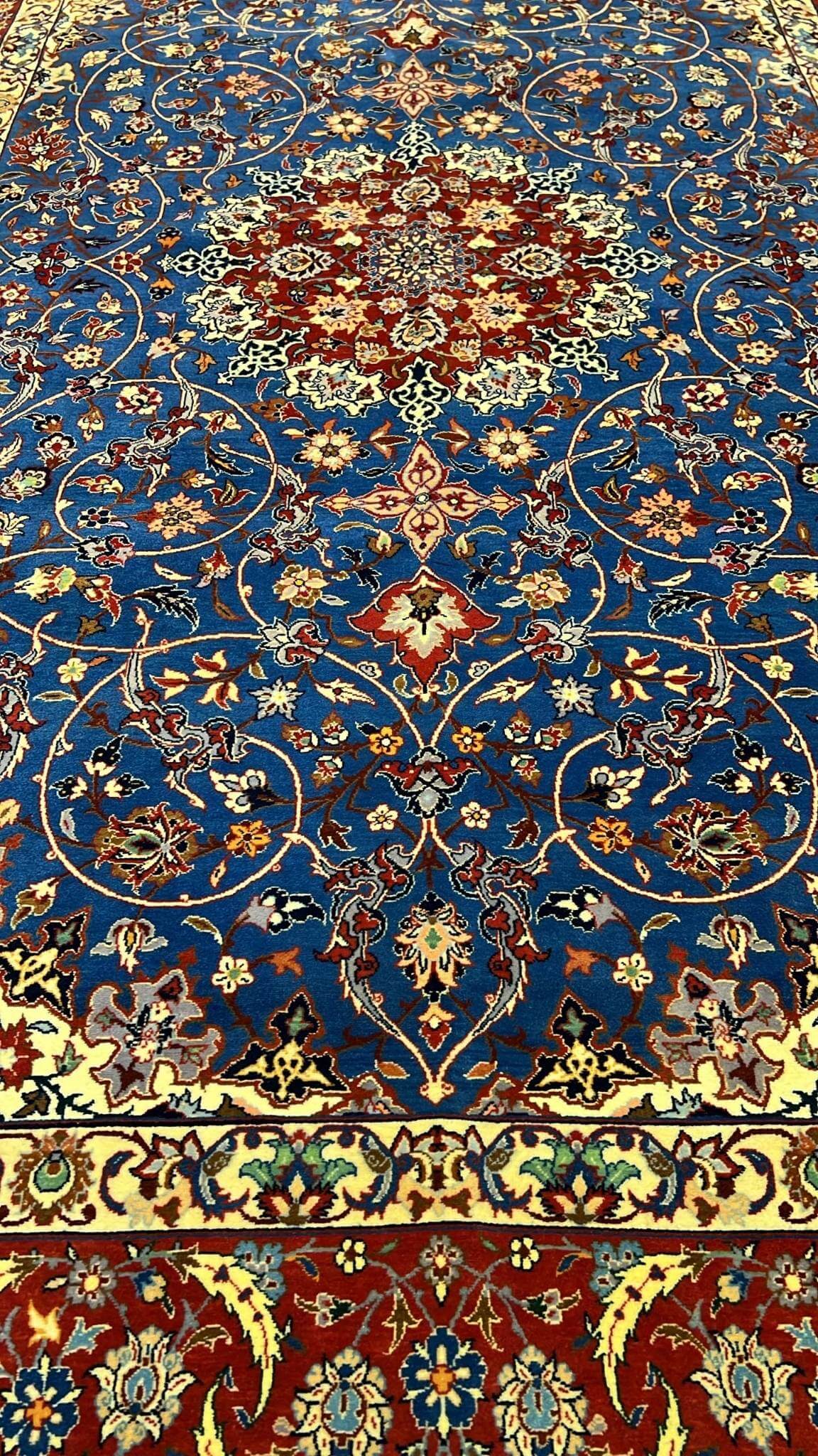 "Close-up of intricate knotting and floral patterns on a Sadegh Seirafian vintage Persian rug, highlighting wool and silk details."








