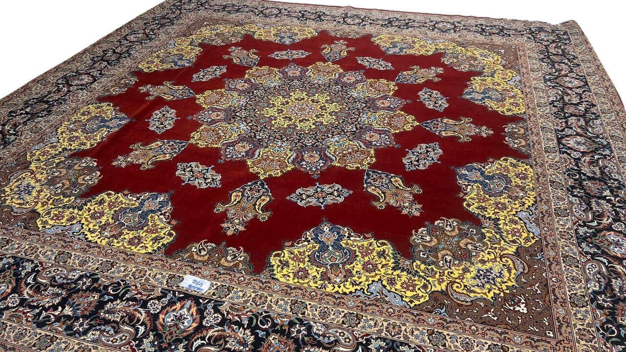"Master Bagher Seirafian’s handwoven Isfahan rug with a black border and intricate floral details."
