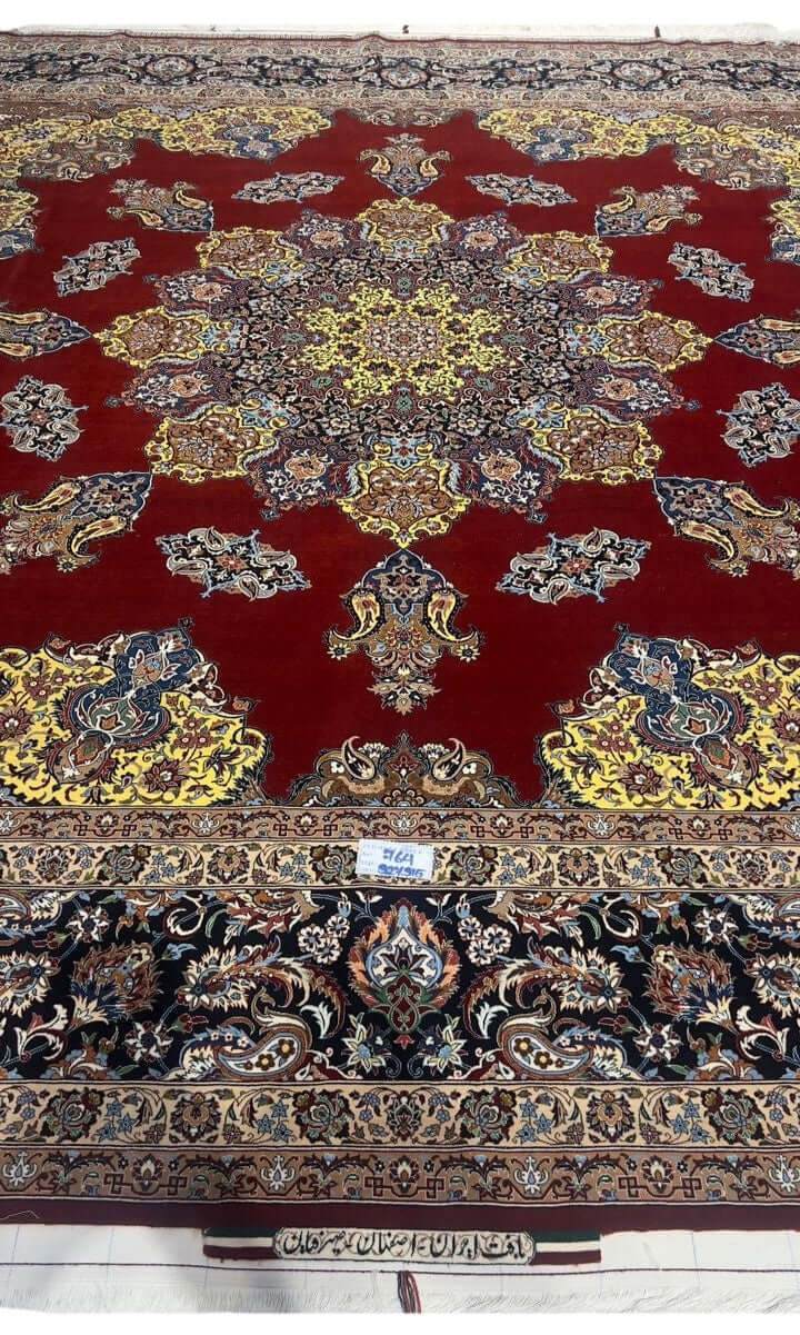 "Hand-knotted Isfahan rug by Master Bagher Seirafian with crimson red field and yellow medallion."
