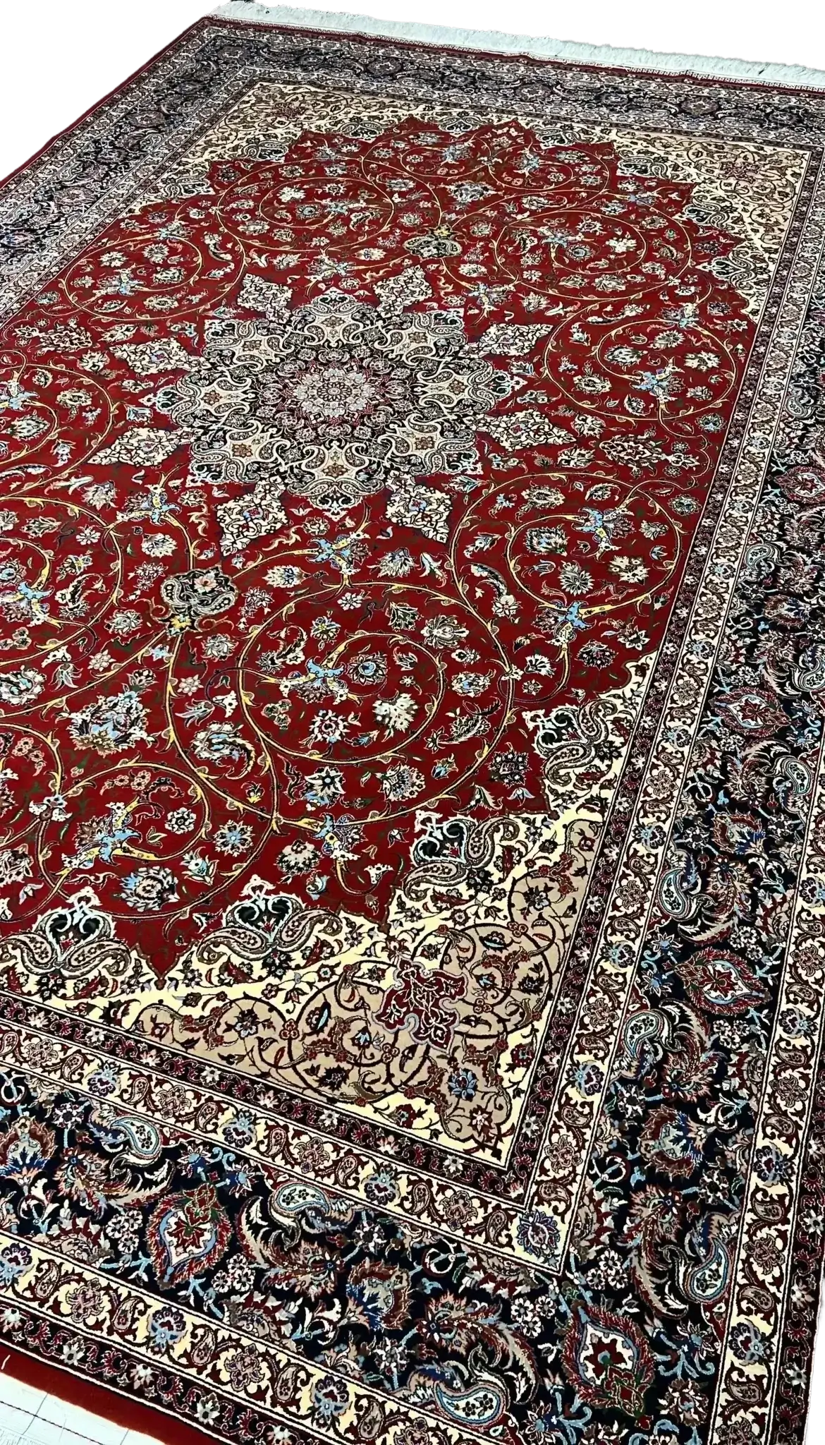 "320 x 215 cm Persian rug from Isfahan, knotted by hand with silk warp and a fine wool-silk pile, crafted by renowned weaver Bagher Seirafian."