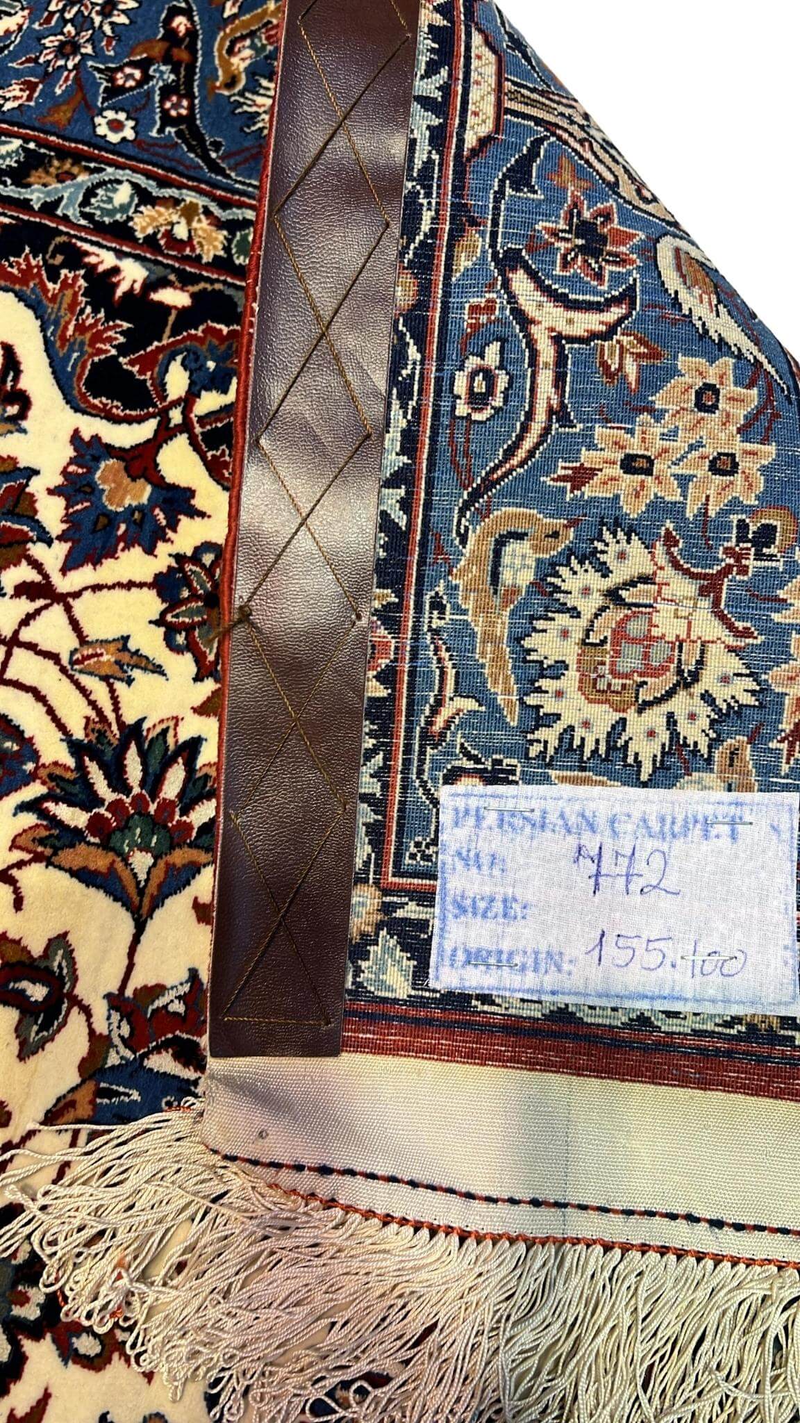 "Backside of a hand-knotted Seirafian Persian rug, revealing the intricate silk warp and craftsmanship by Master Ahmad Seirafian."

