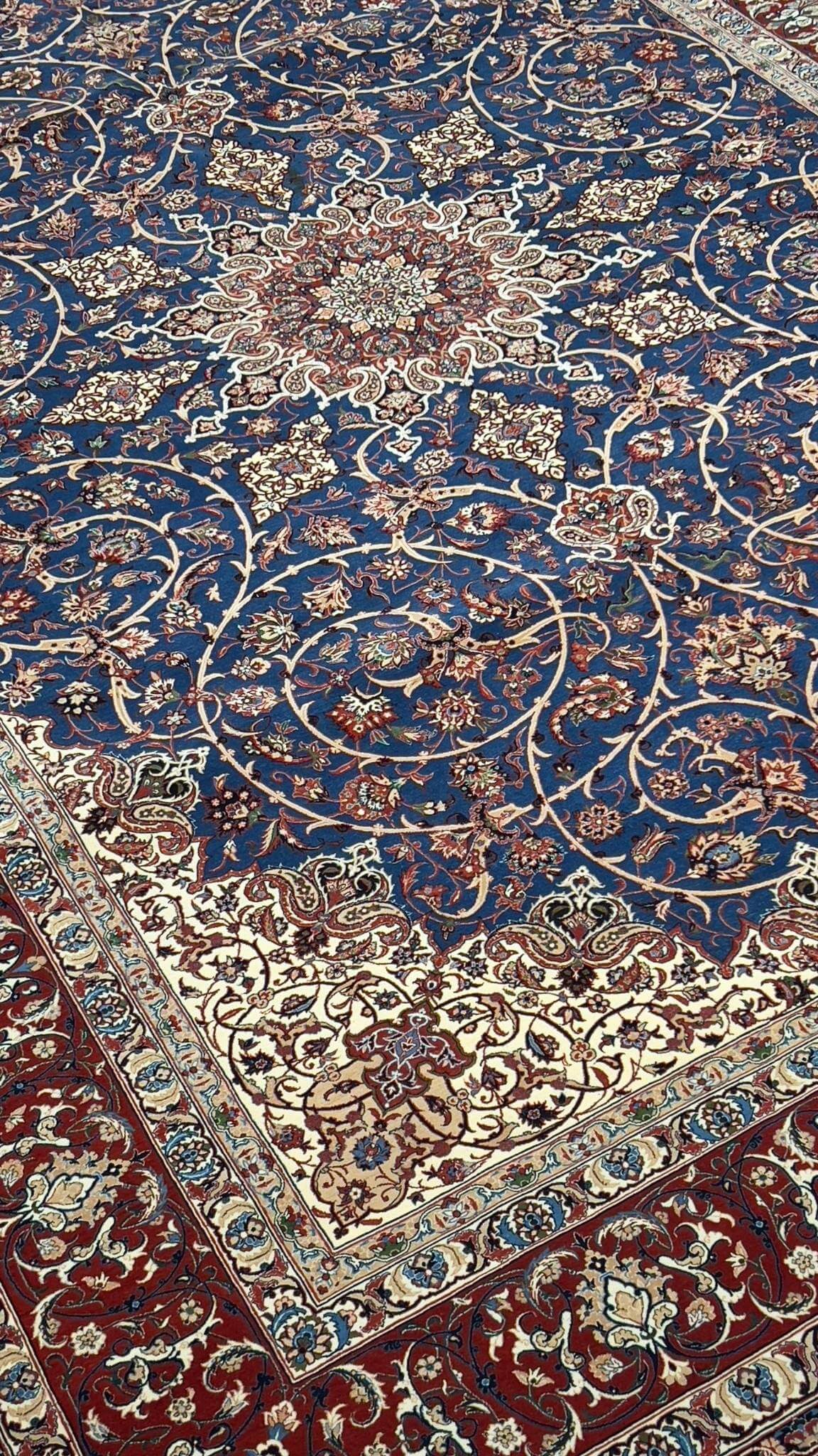 "Exquisite Persian rug featuring floral motifs and paisley patterns in rich navy, red, and ivory."

