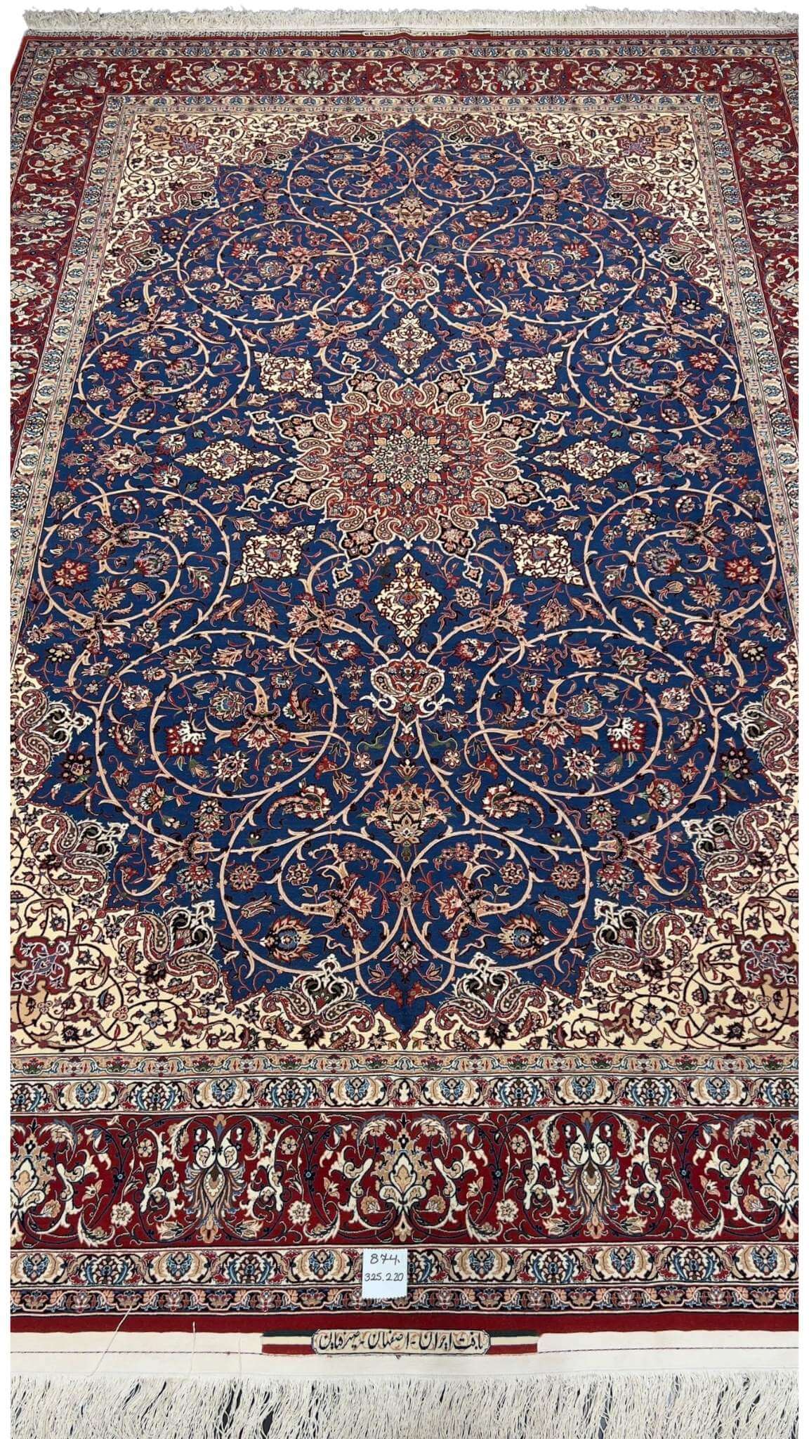 "Hand-knotted Isfahan rug by Master Bagher Seirafian with a navy blue field and red medallion."
