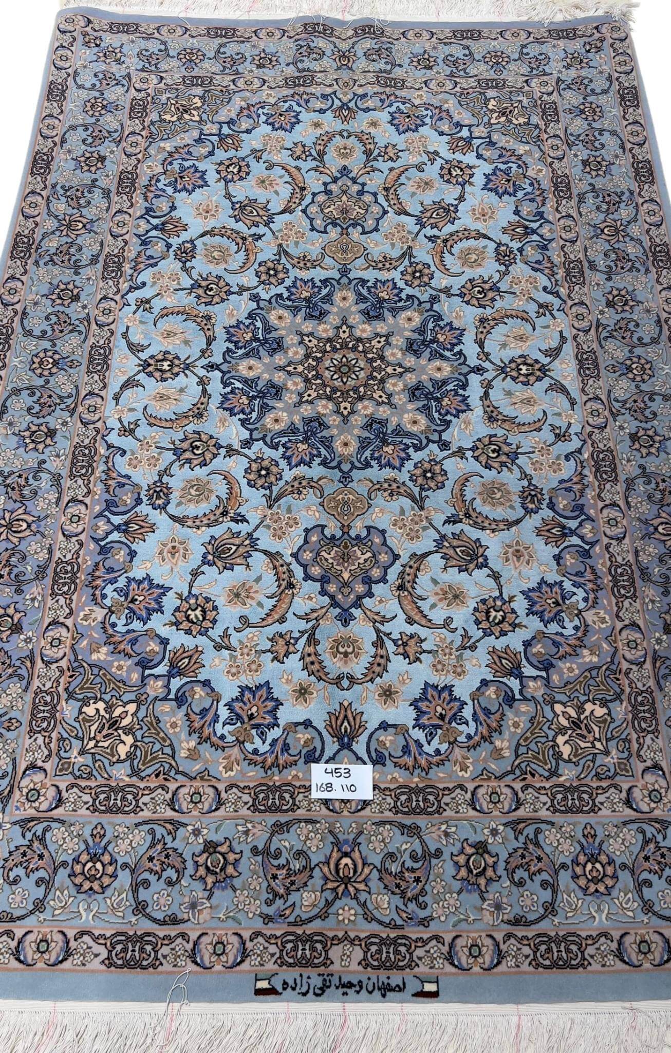 Hand-knotted Persian rug with a sky-blue base and intricate medallion design.
