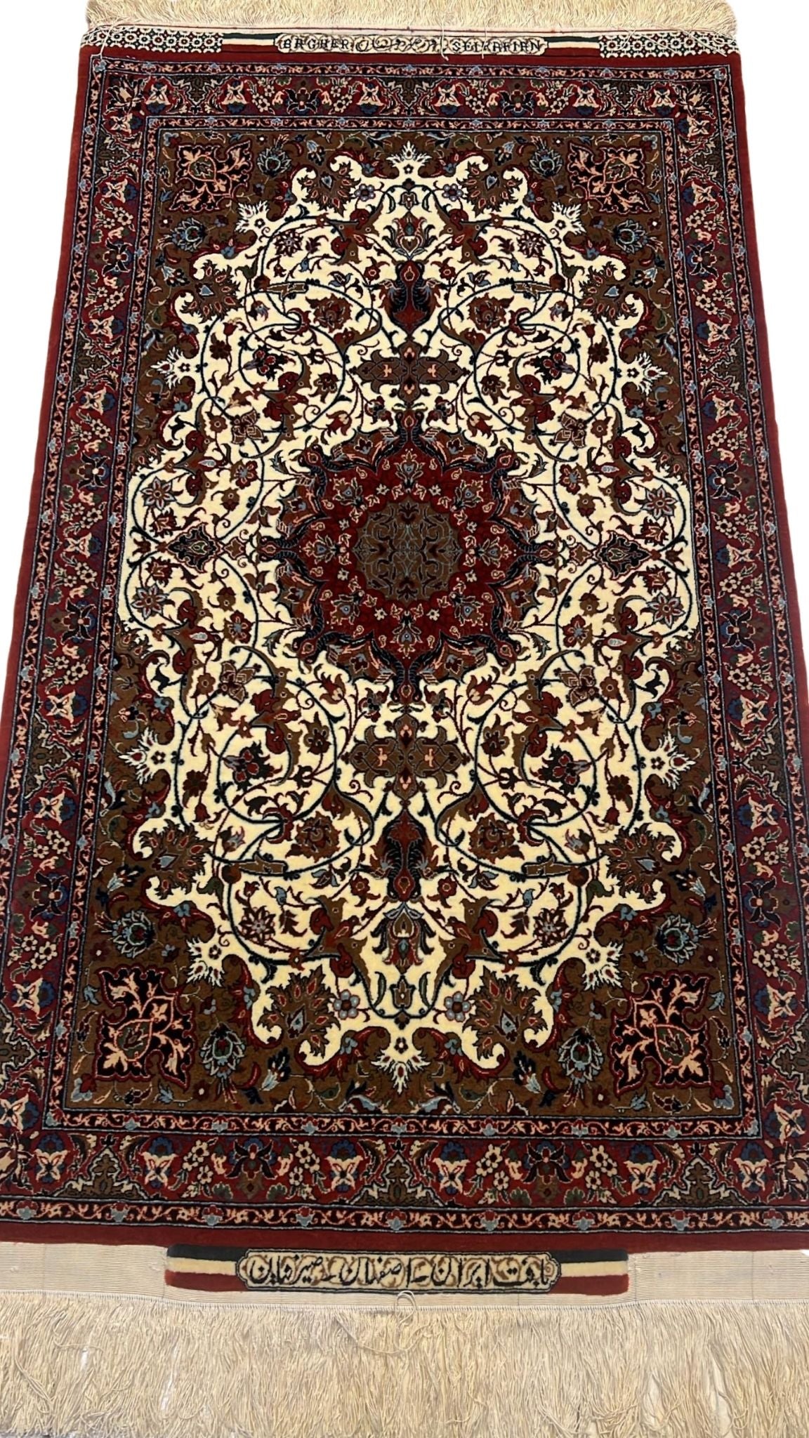 Fine small red and cream Seirafian Persian rug with intricate floral patterns.

