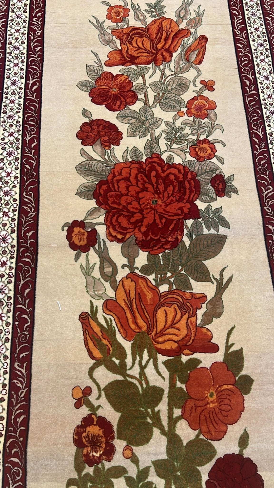 Close-up of the intricate floral patterns on the Seirafian beige runner rug.
