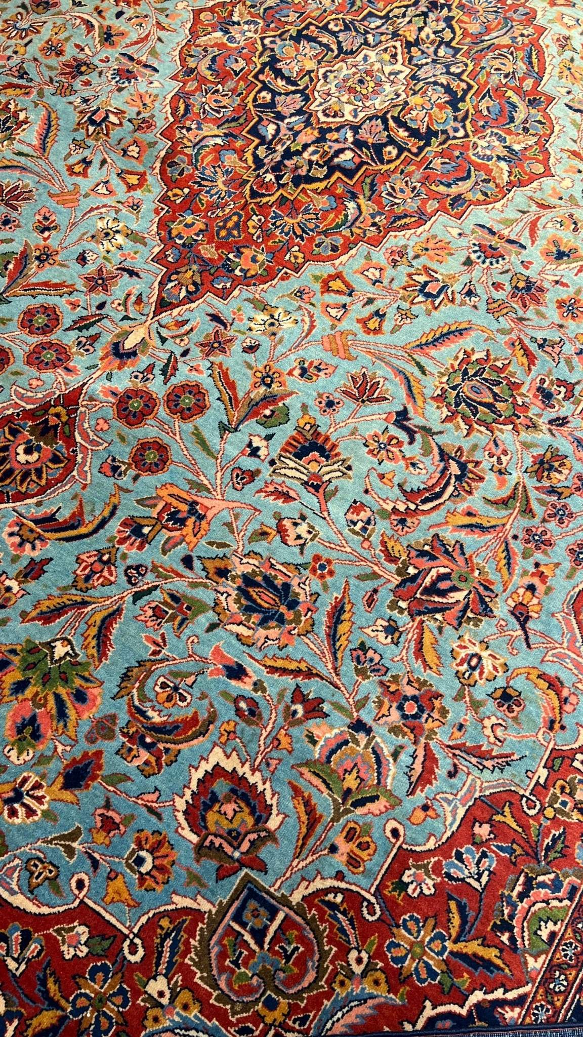 "74-year-old antique Persian Kashan rug with turquoise and red floral patterns, hand-knotted in Iran by Safarzadeh"
