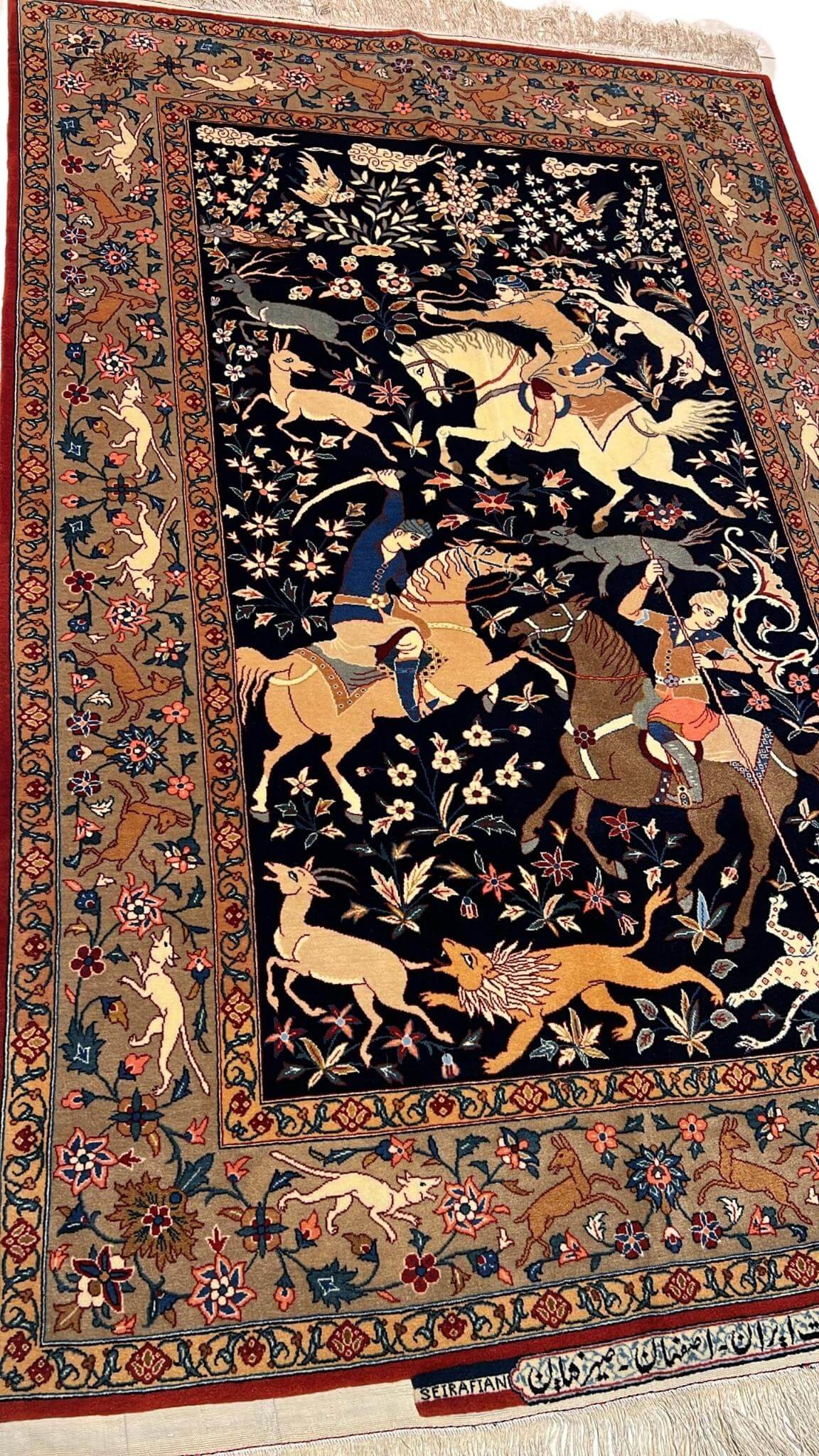 Full view of the 60-year-old Seirafian Persian rug with a hunting scene design, in excellent condition.
