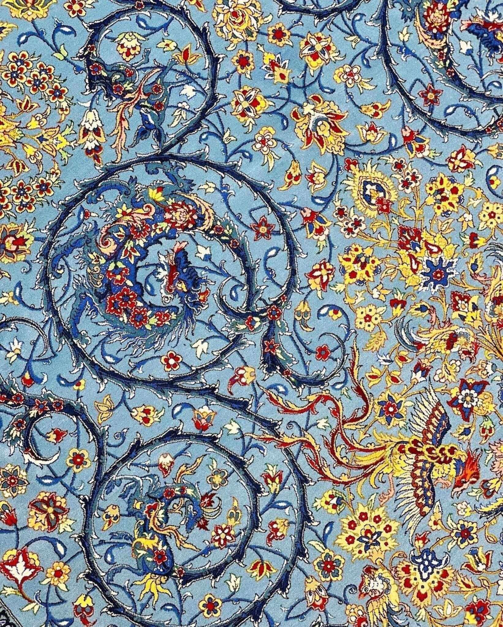 Handwoven Persian carpet with intricate blue and gold floral designs
