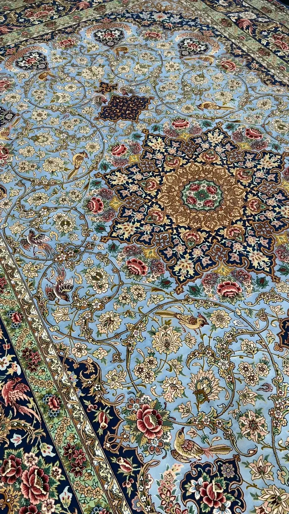 Plush oriental silk carpet with a dominant light blue shade and detailed patterns