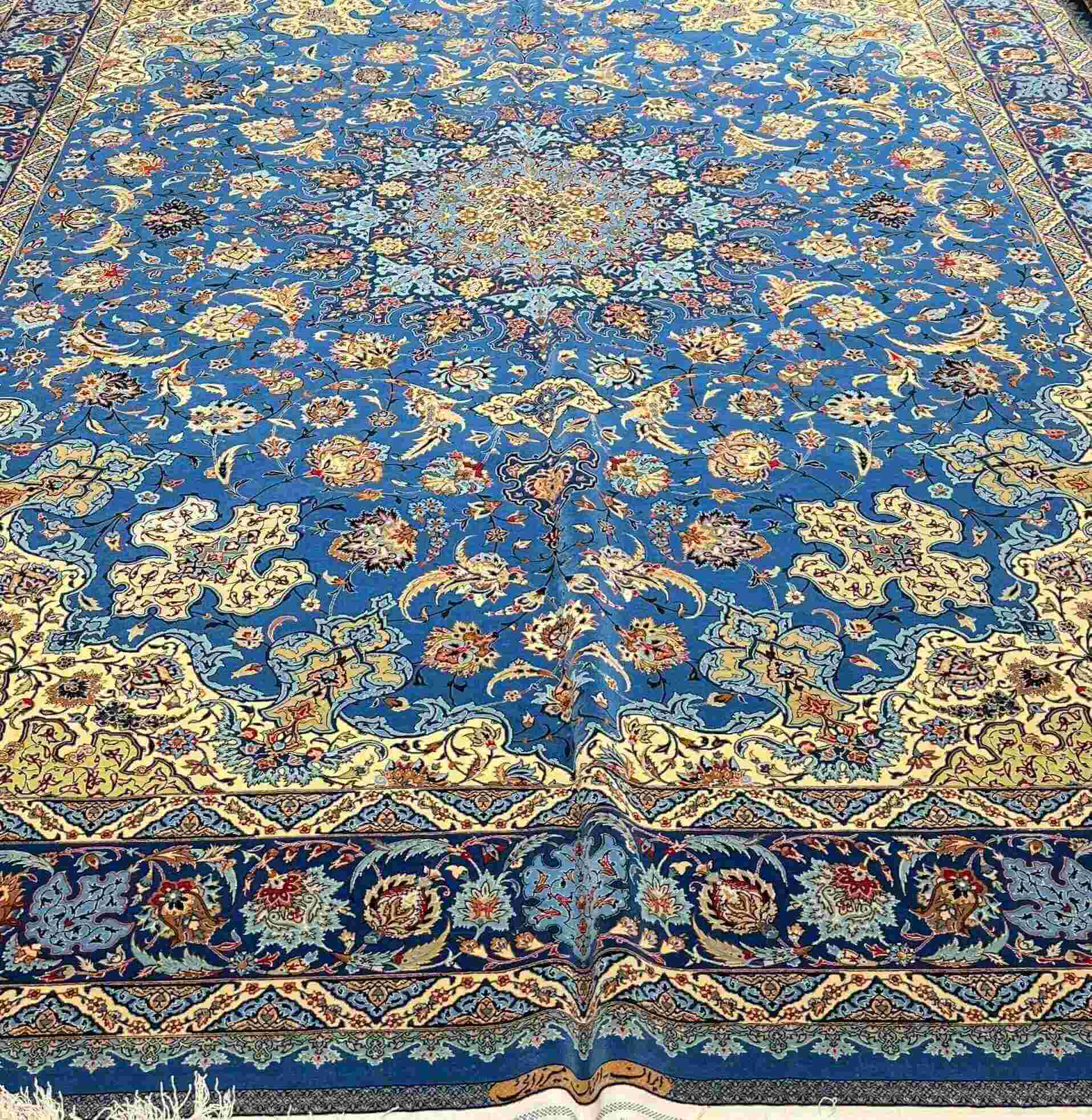 Luxury Handmade Persian Silk Rug – This 9x12 ft Persian Qum silk rug, hand-knotted by skilled artisans in Isfahan, offers timeless beauty and superior craftsmanship.
