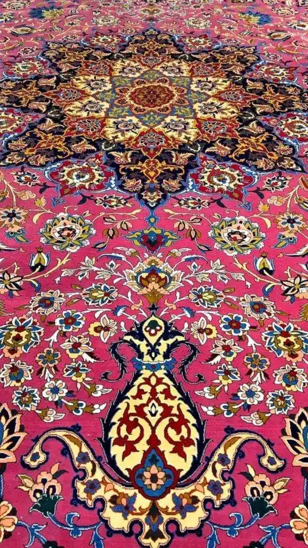 Detailed corner view of the purple oriental rug, showcasing a vibrant mix of colors and intricate floral designs against a purple background.
