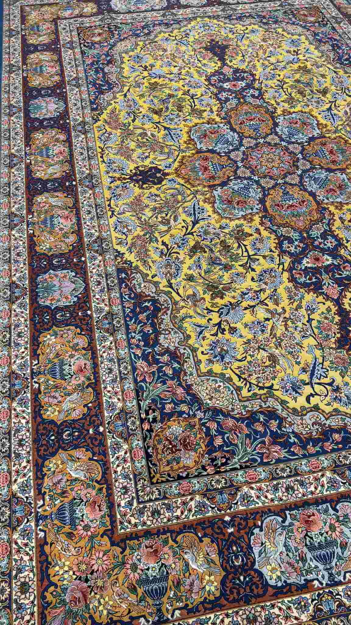 "Close-up view of the intricate floral design and silk field on the Isfahan Persian rug."
