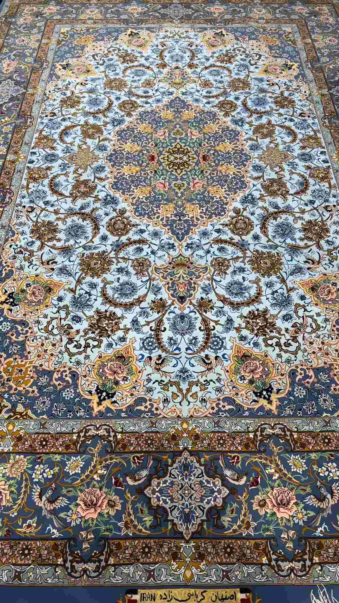 "Side view of the finest light blue Persian carpet, showcasing the hand-knotted craftsmanship."