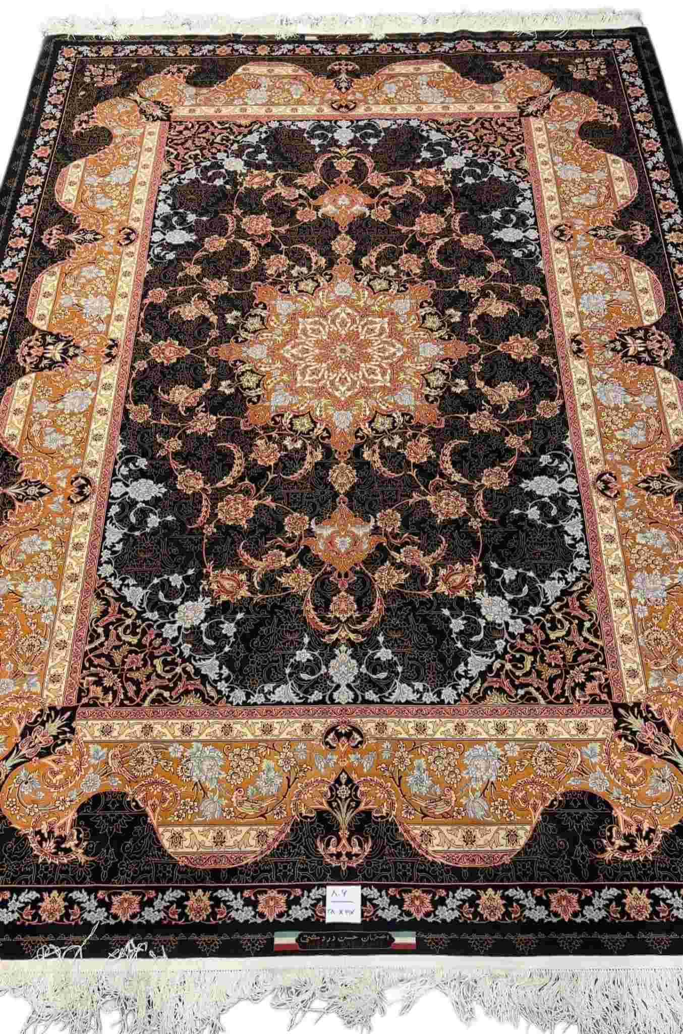 "Hand-knotted black Persian rug with silk medallion, 9.2 x 6.5 ft, by Master Hassan Dardashtie."