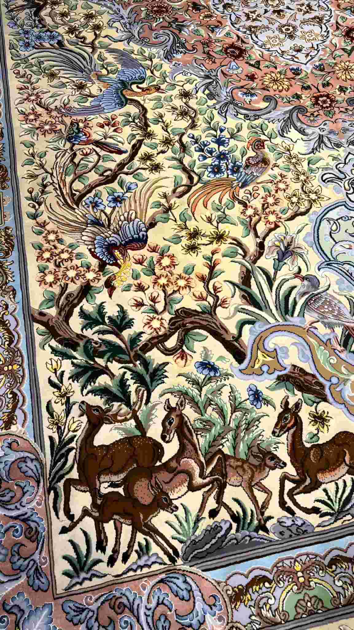 "Exquisite Isfahan silk Persian rug featuring floral and animal motifs, available online."