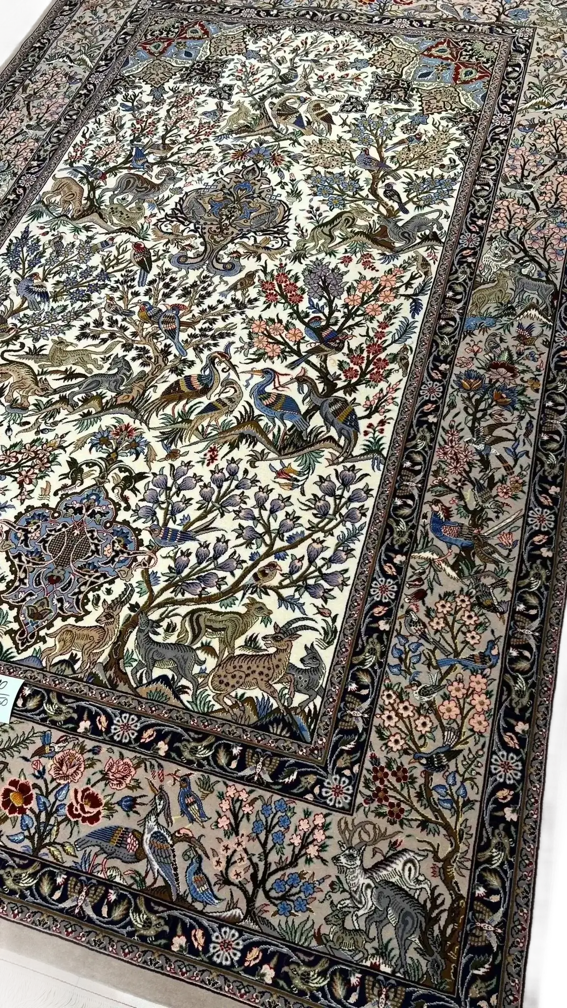 Spacious oriental-style rug with elaborate floral patterns on silk and wool