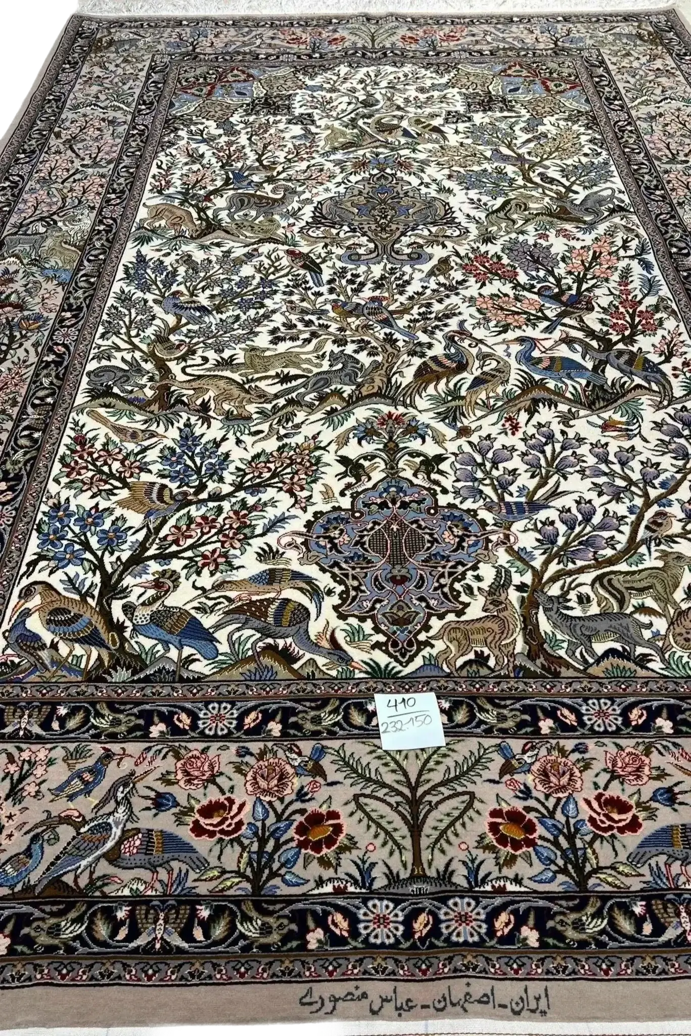 Silk and wool rug featuring an intricate tree and bird pattern