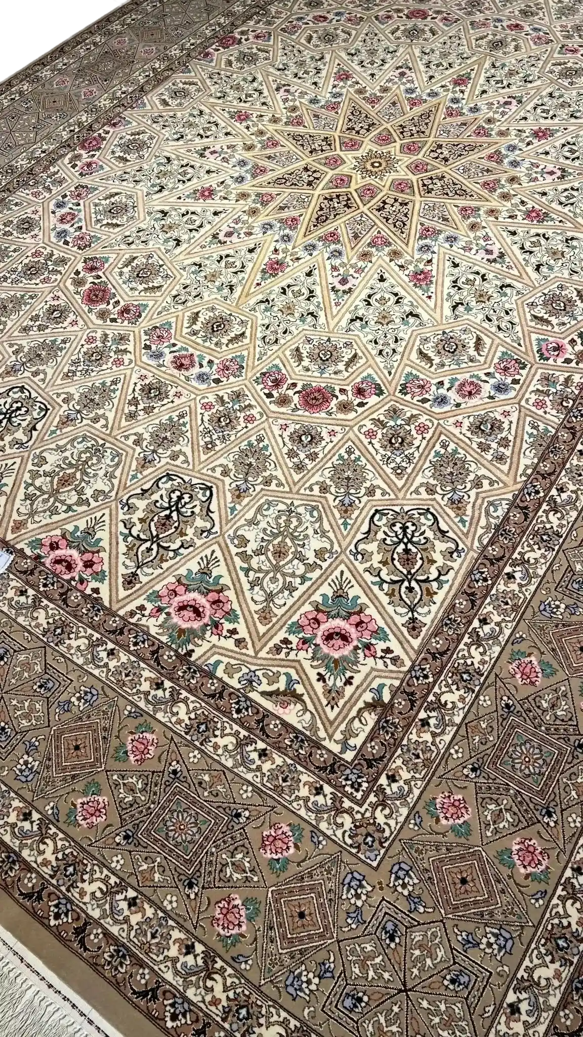 Full view of a beige Persian rug with elaborate floral designs