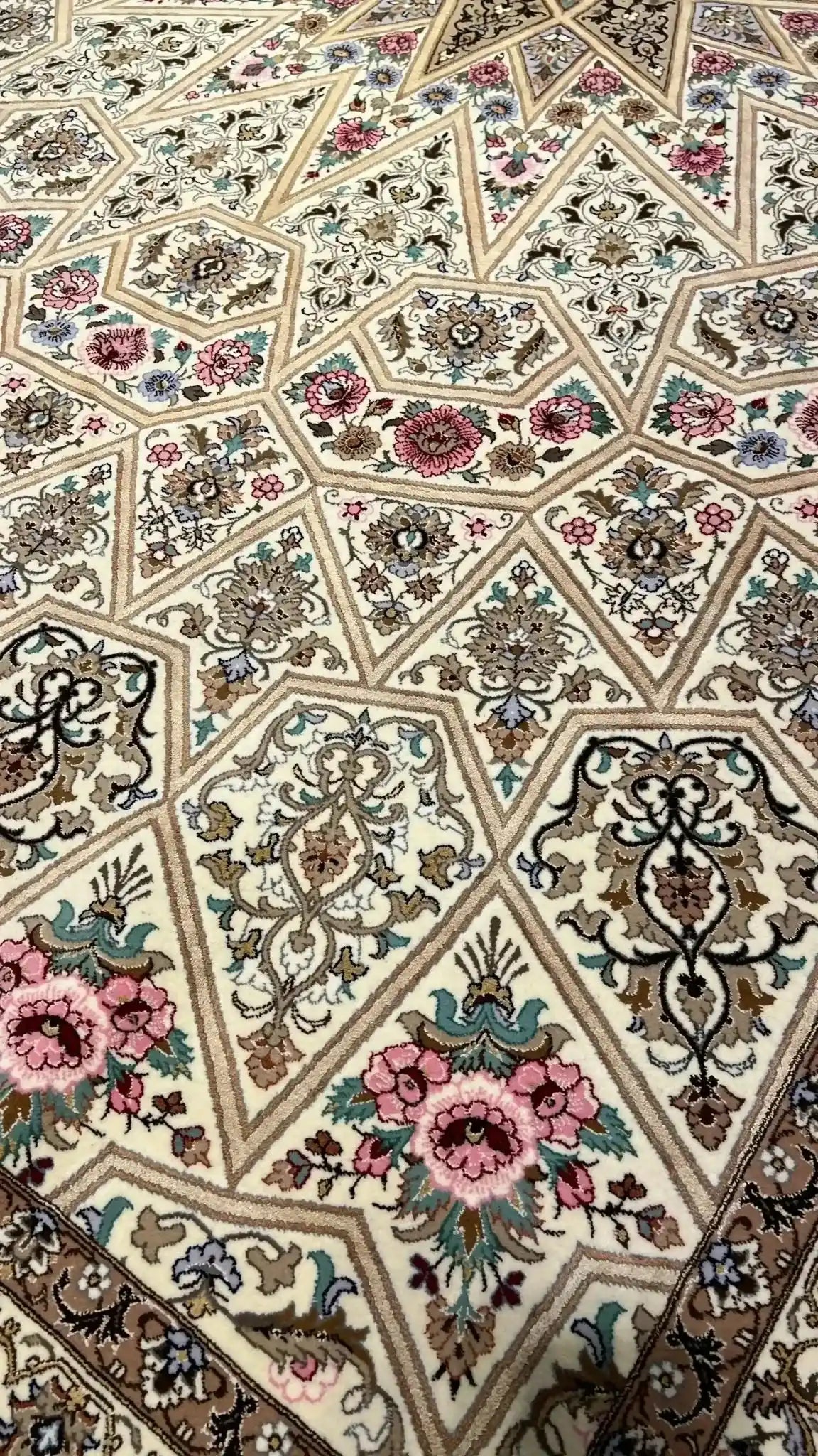 Full view of a beige Persian rug with elaborate floral designs