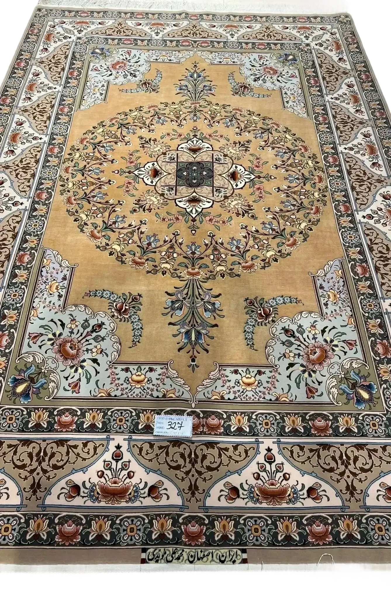 A detailed view of a luxurious Isfahan carpet with elaborate floral motifs and rich colors