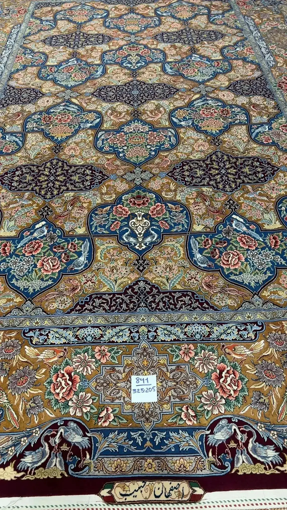 Colorful Persian rug from Isfahan featuring floral and bird motifs, hand-knotted with silk and wool blend.
