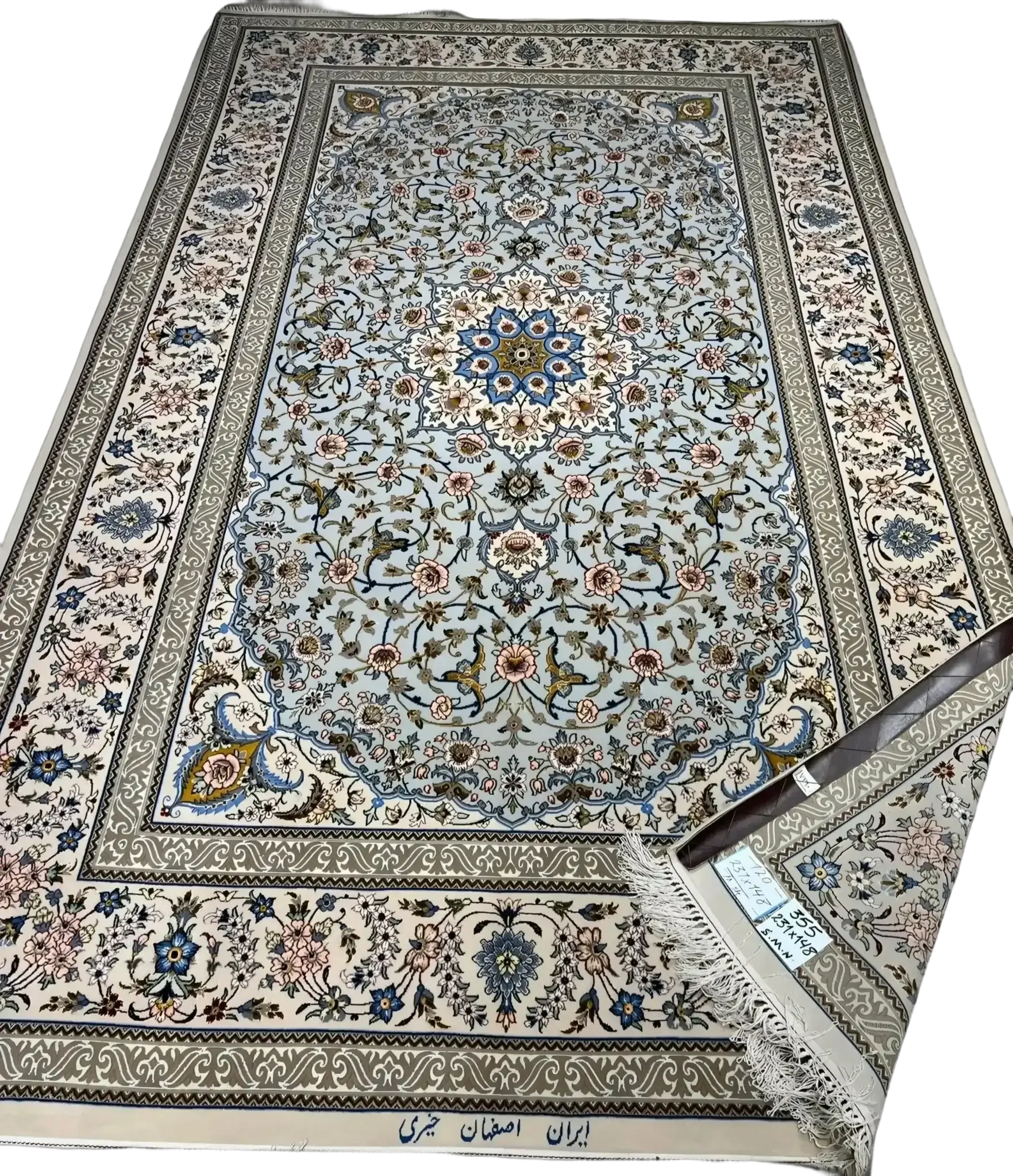 Detailed view of the Kheirie rug with light blue and beige floral motifs