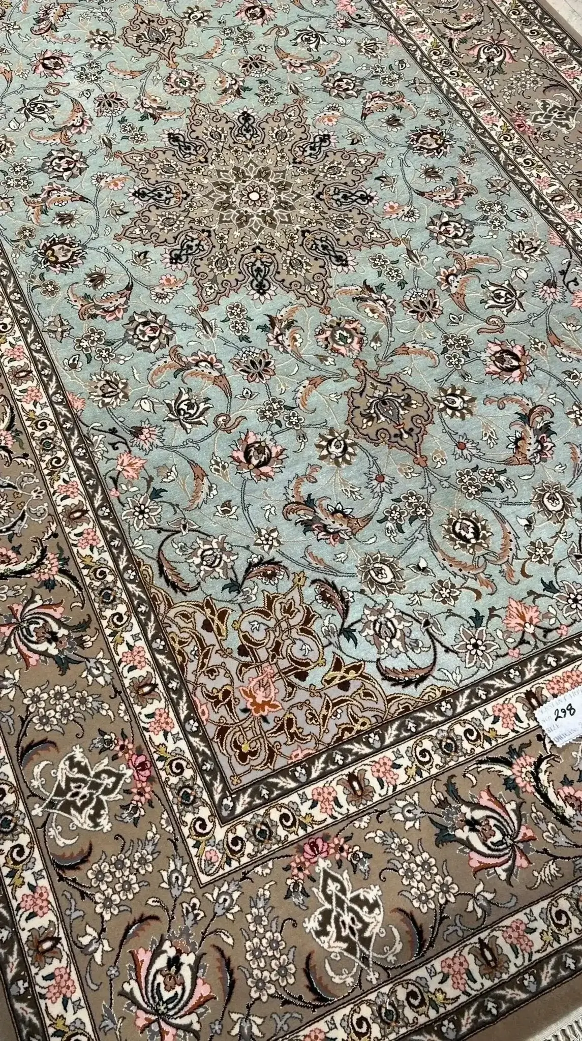 Luxurious silk and wool carpet measuring 230 cm by 145 cm with intricate floral patterns