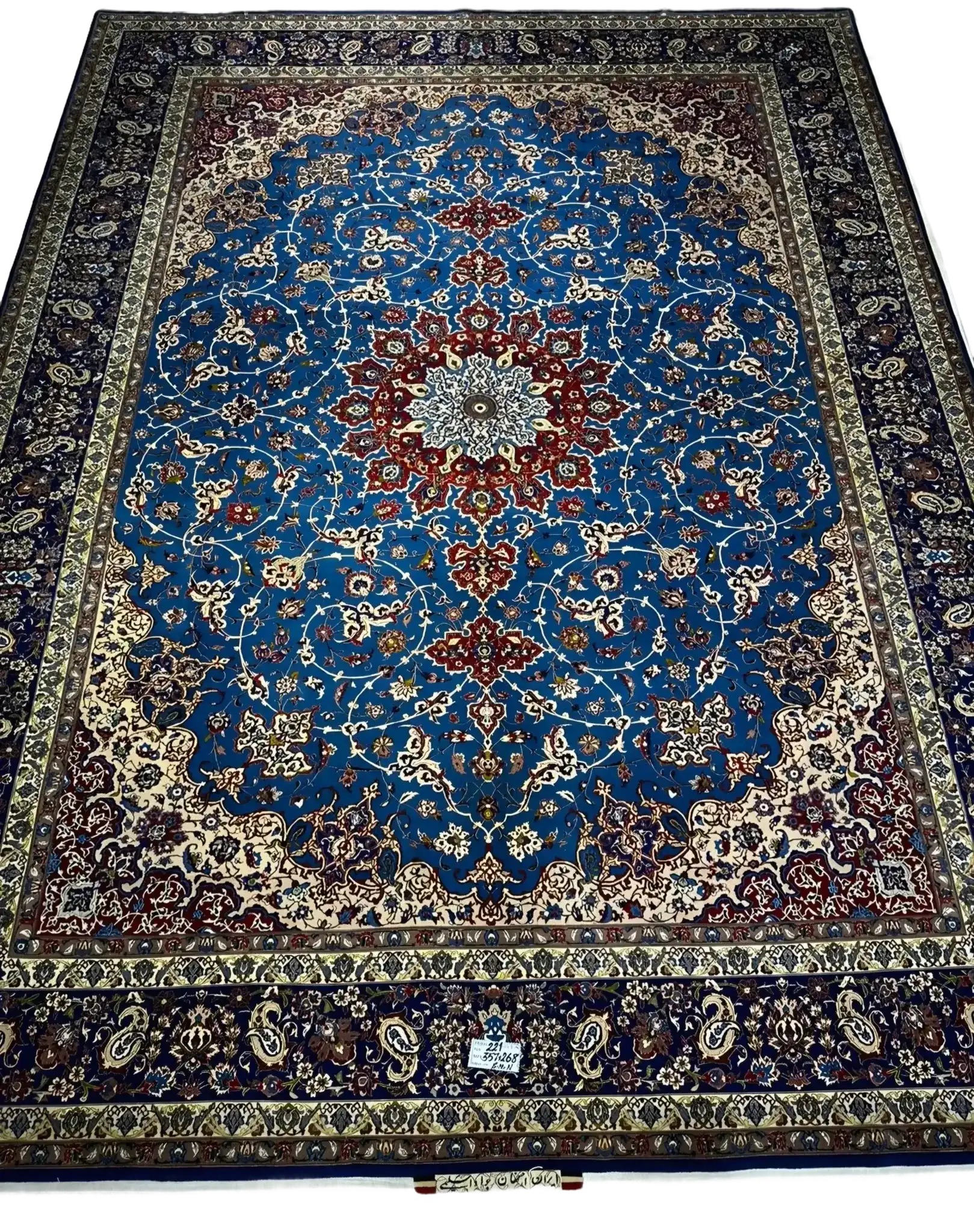 Majestic Persian Rug with Blue and Red Medallion Design – A full view of a large hand-knotted Persian rug, featuring a striking blue field with intricate red and ivory medallion patterns, bordered by elegant floral motifs, perfect for adding grandeur to any room.

