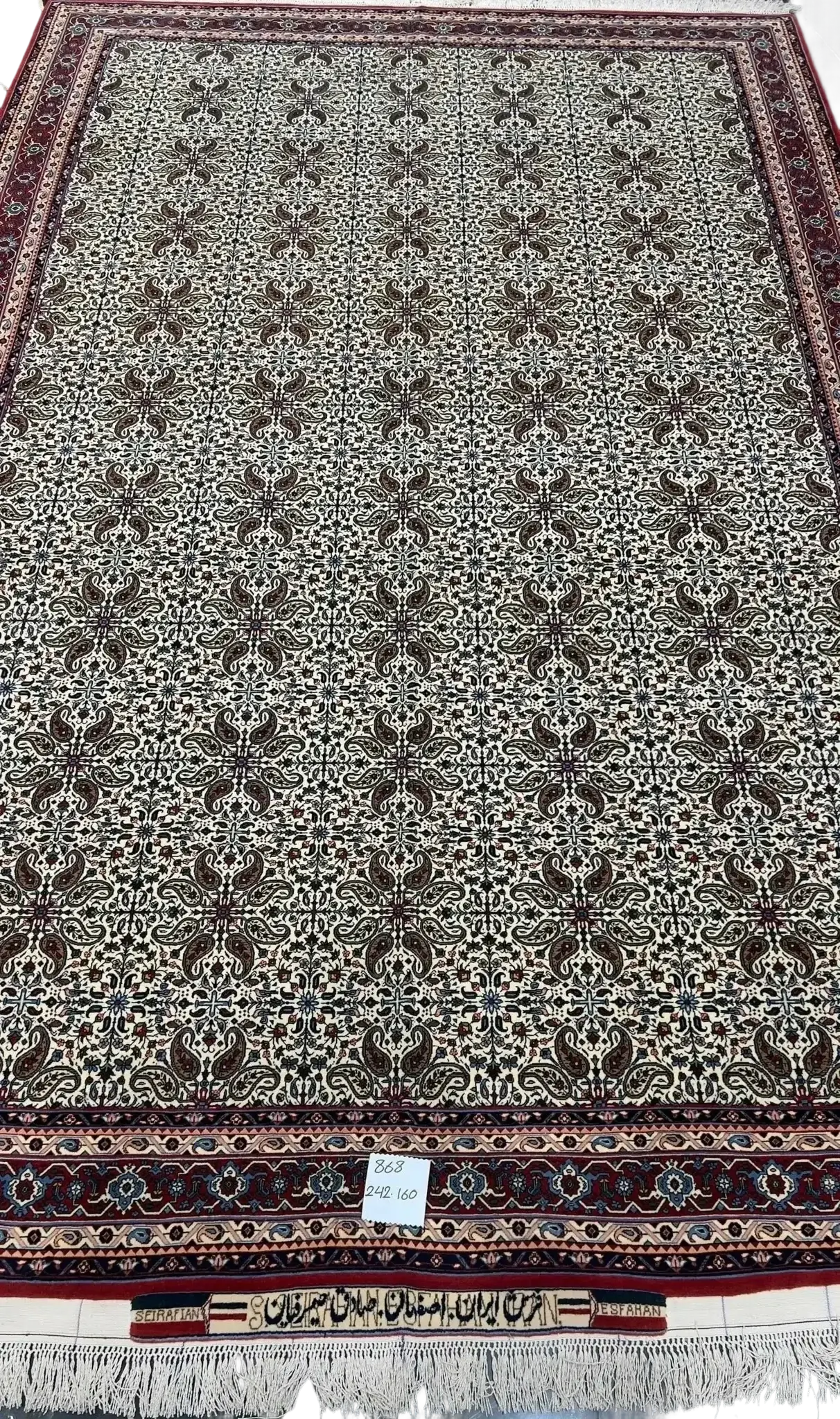 "Hand-knotted Sadegh Seirafian Persian rug featuring intricate symmetrical floral motifs with high knot density, originating from Isfahan."
