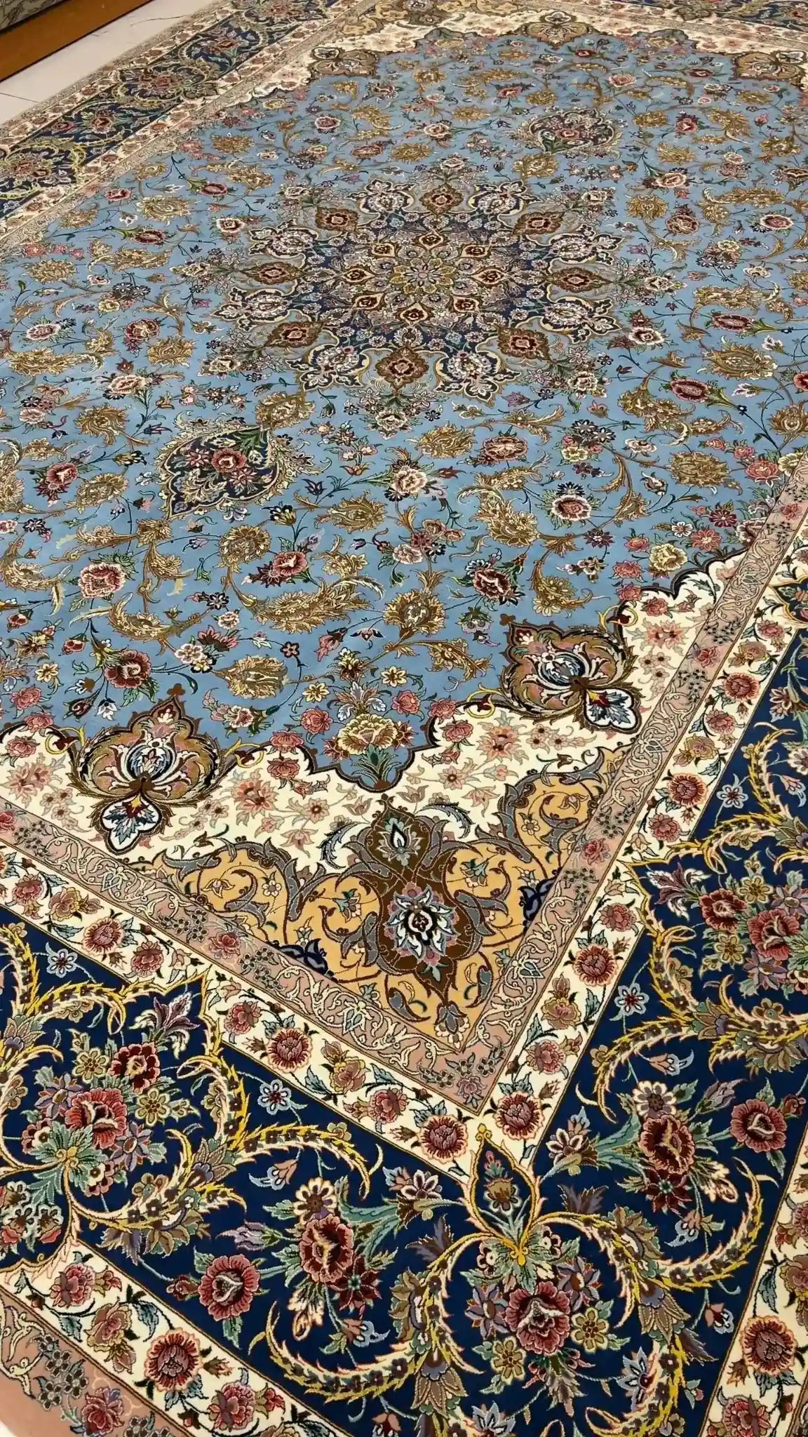 "Detailed corner view of a Persian Sheikh Bahaie rug, with floral motifs and a blend of silk and wool."
