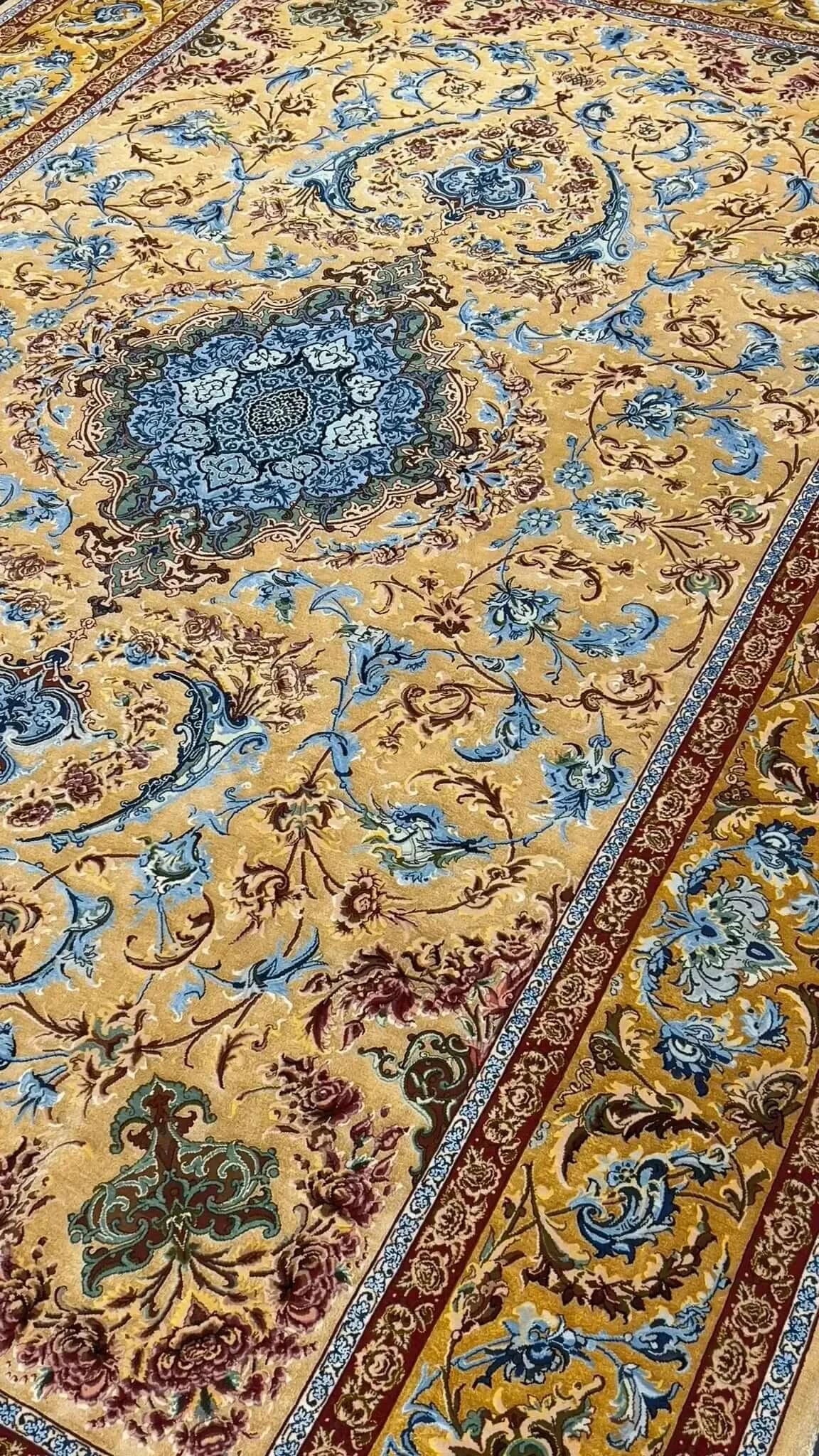 Elegant Mohaghegh silk carpet featuring blue and golden motifs