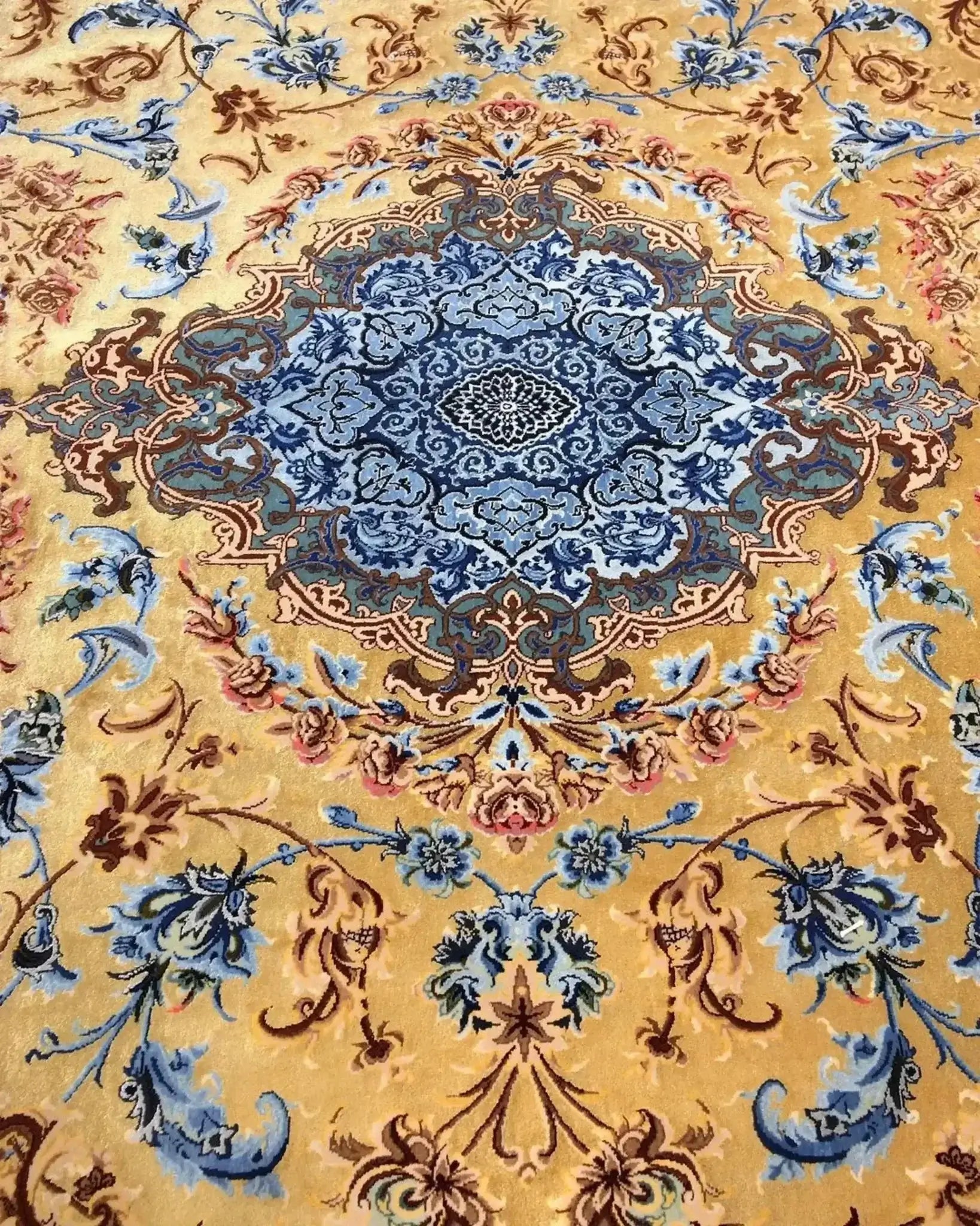 Mohaghegh silk carpet showcasing a prominent central medallion design