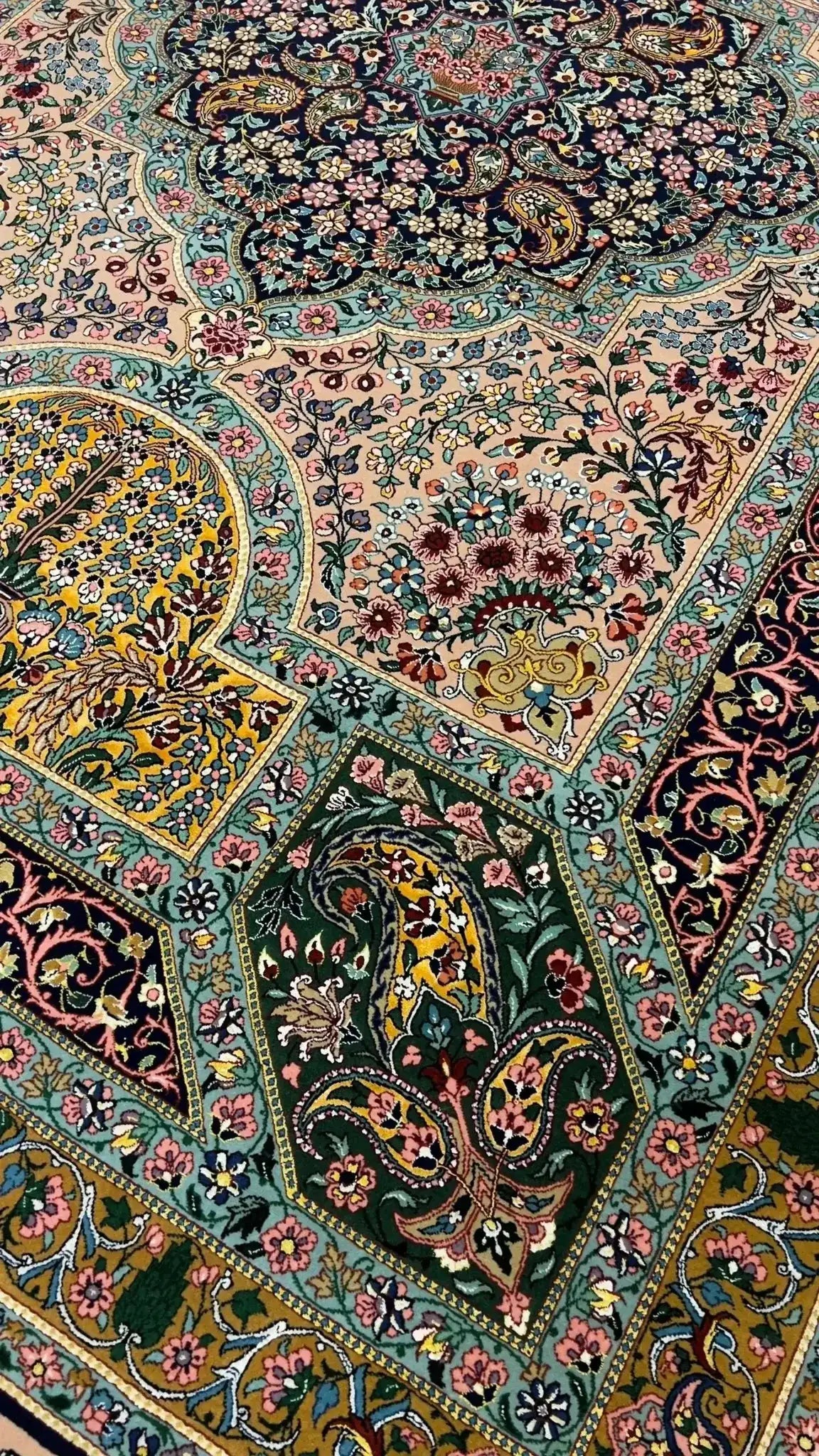 Corner Detail of Samavie Persian Rug – A close-up shot of the corner of the Samavie Persian rug, highlighting the intricate floral design and vibrant color contrasts in the wool and silk blend.

