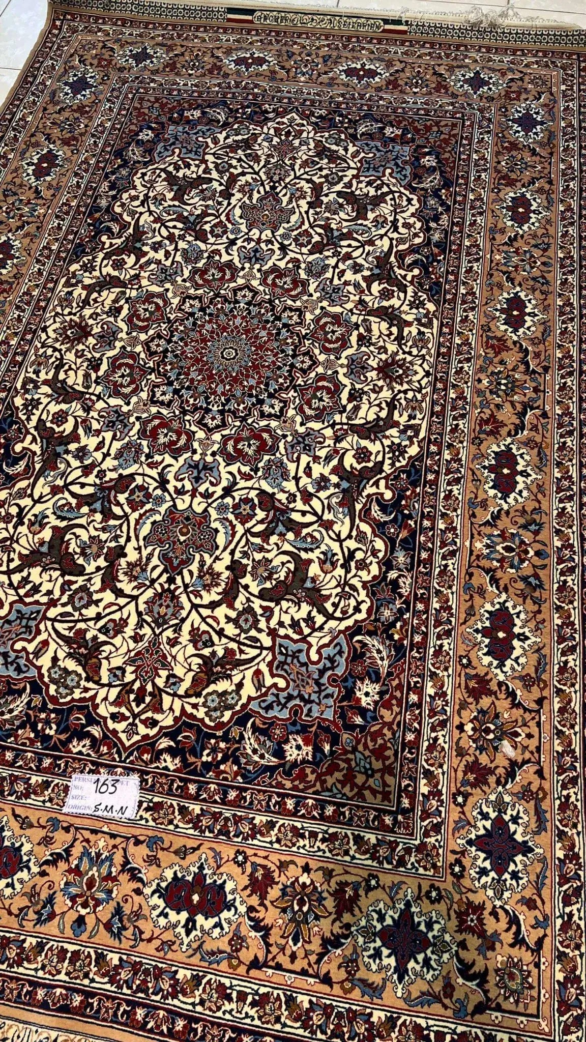 "Authentic Seirafian rug for sale, featuring detailed Persian craftsmanship, made from wool and silk with traditional floral patterns."