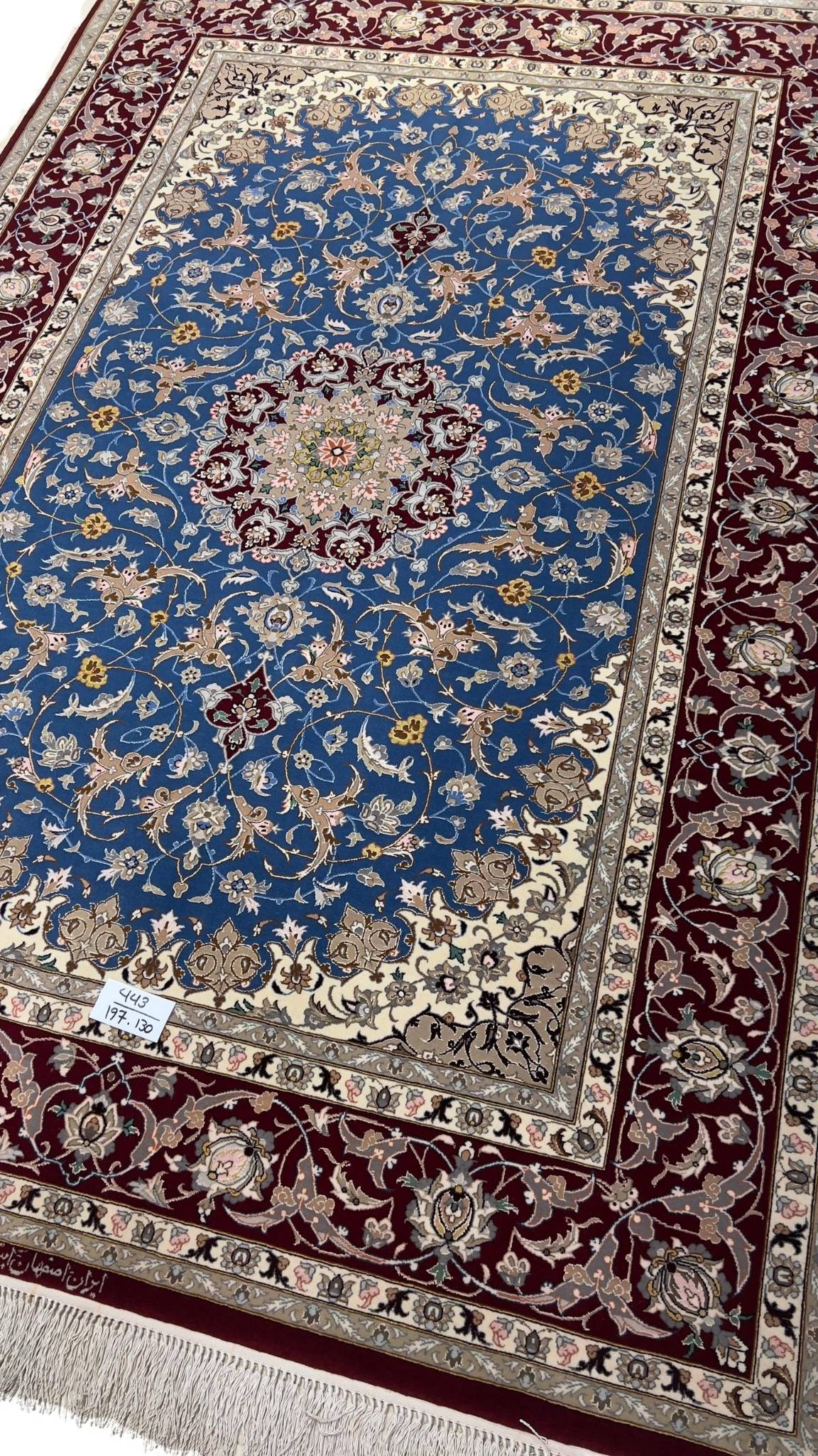 Classic Persian rug in red and blue with a central medallion and floral motifs