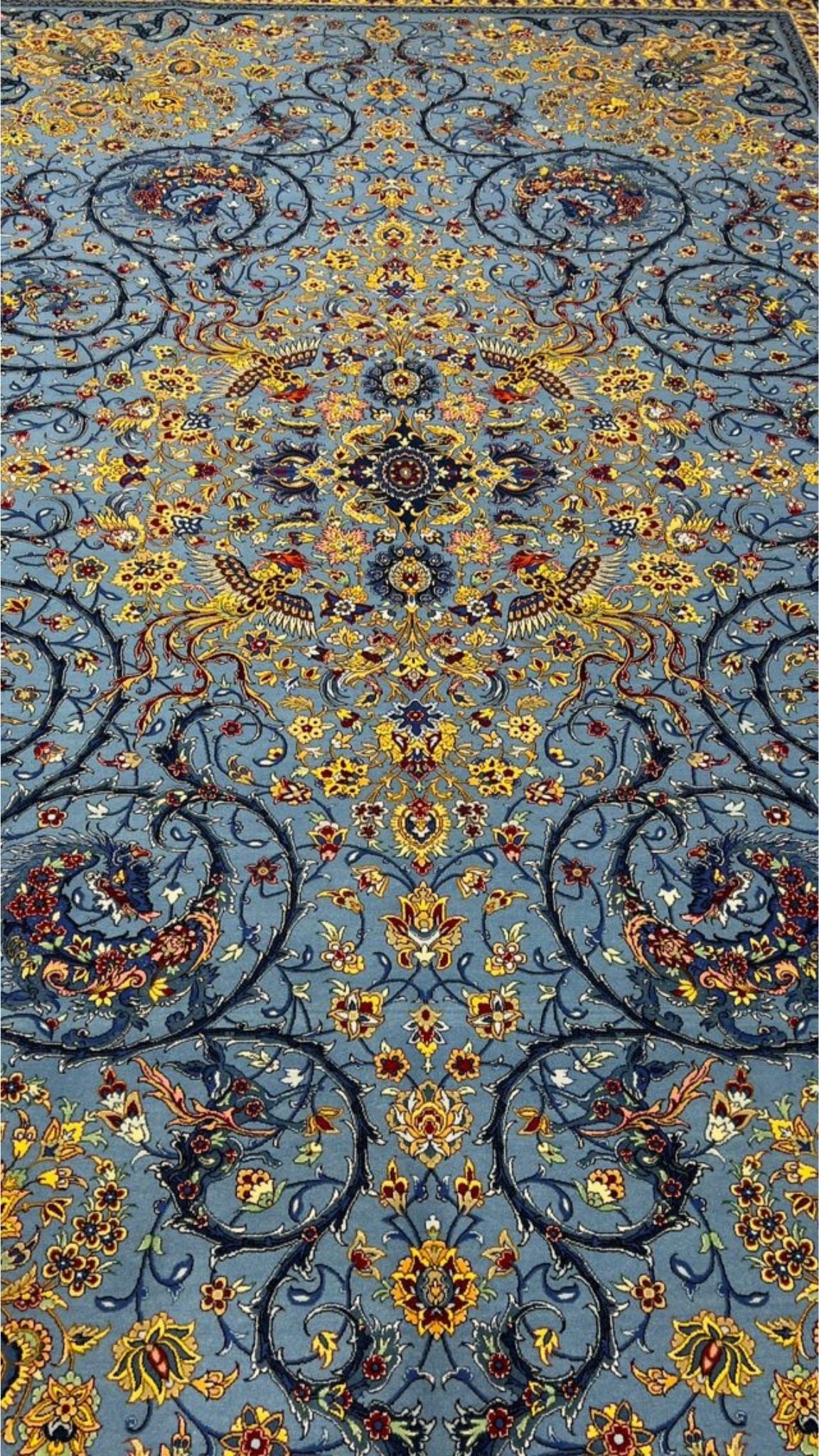 Traditional blue Persian carpet with floral designs and fine details
