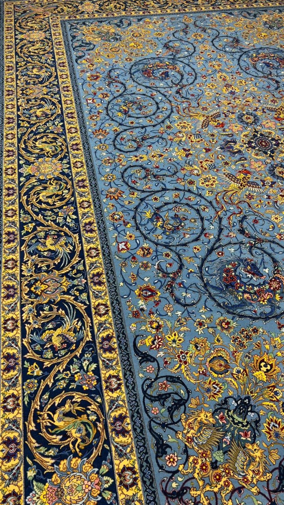 Traditional Persian rug with a blue background and floral motifs
