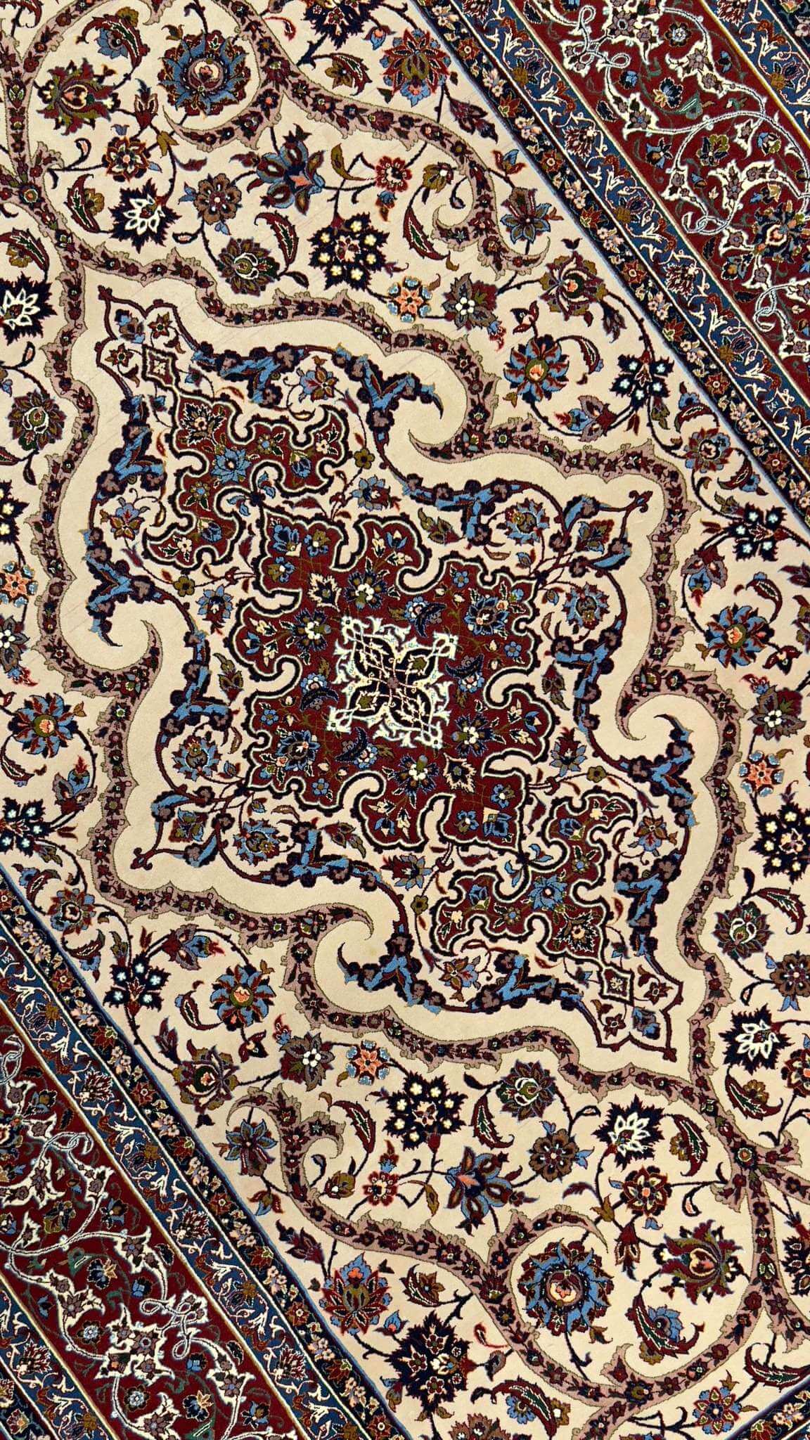 A stunning antique Persian rug from Isfahan, Iran, handcrafted with a luxurious blend of wool and silk using natural dyes. This unused 50-year-old rug features intricate designs and knot density of 1,210,000 per square meter, showcasing the fine craftsmanship of the Saraf Mamouri workshop. Measuring approximately 225 x 150 cm (7.4 x 4.9 feet) with a thickness of 6 mm, this masterpiece blends tradition, history, and elegance into a single unique piece, offering a rare opportunity to own a one-of-a-kind antiq