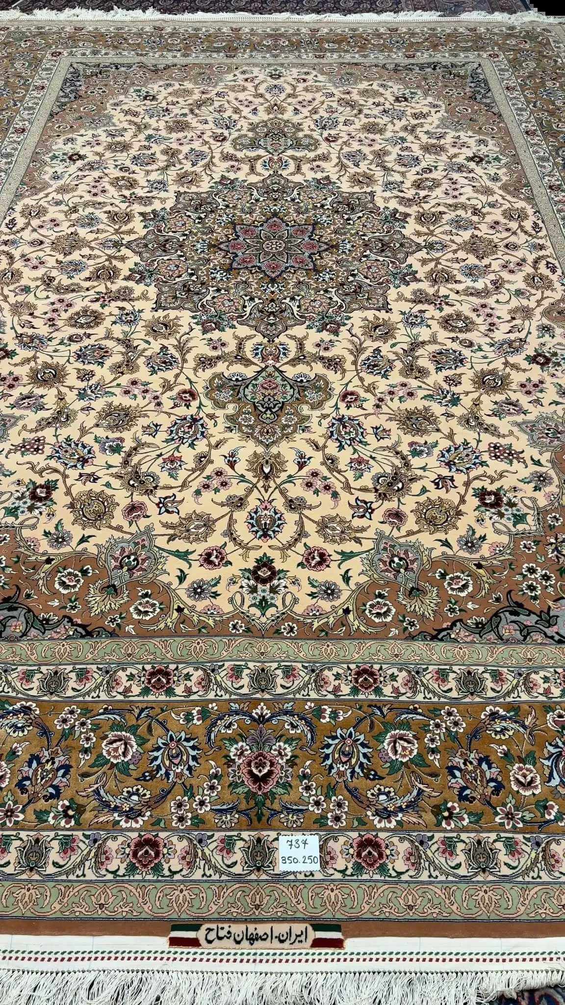 Full display of the elegant beige hand-knotted Iranian rug with floral designs