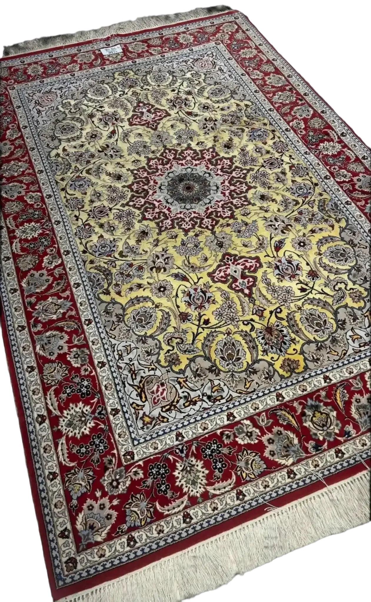 Nael Isfahan's handcrafted carpet featuring red and yellow patterns with central medallion