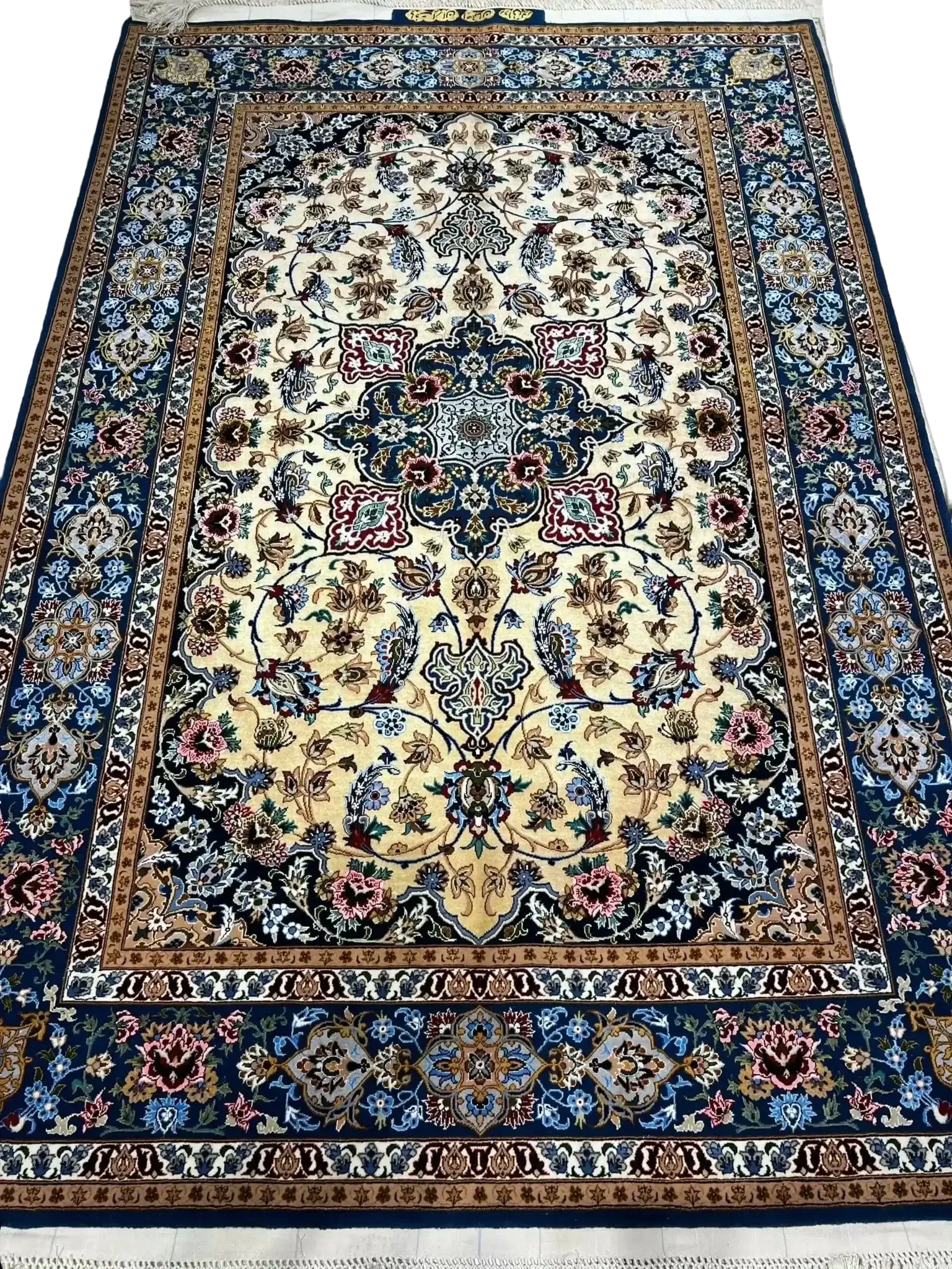 A luxurious gold and blue silk rug from Isfahan with intricate designs