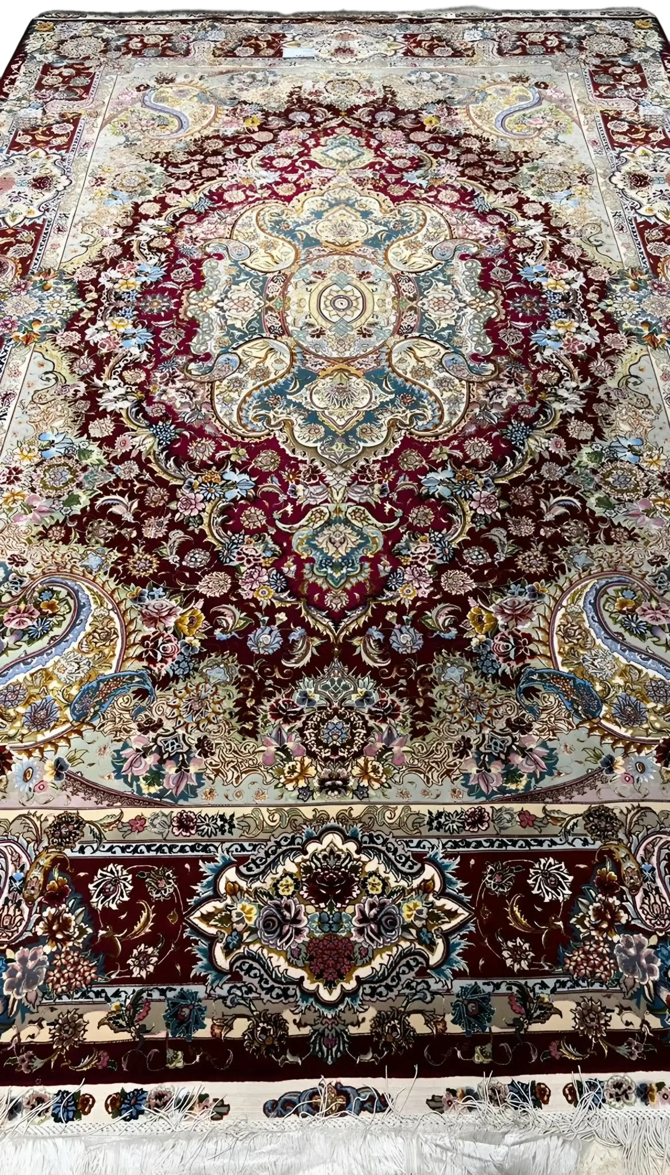 Detailed view of the exquisite craftsmanship on the Tabriz rug with ornate designs