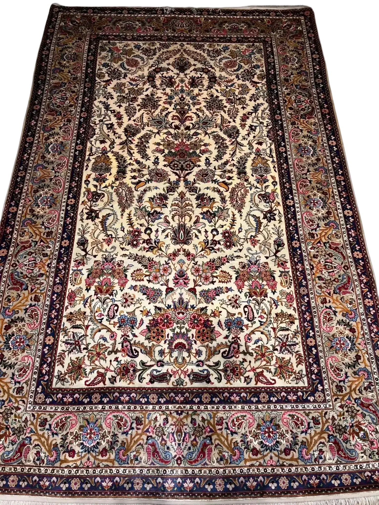 Close-up of the detailed floral motifs on the semi antique Kashan silk rug