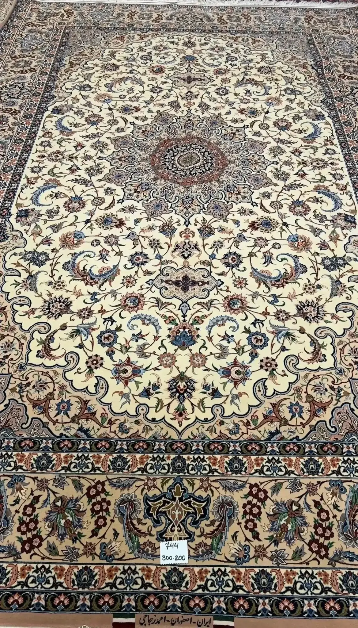 "Hand-knotted Isfahan Persian rug by master weaver Ahmad Zojaji. Measuring 300 cm x 200 cm (approximately 9.8 feet x 6.5 feet) with a knot density of 810,000 knots per square meter, this luxurious rug is crafted with a wool and silk pile and a silk warp. The intricate floral medallion design in soft tones is a stunning new creation from Isfahan, Iran, with one available in stock."