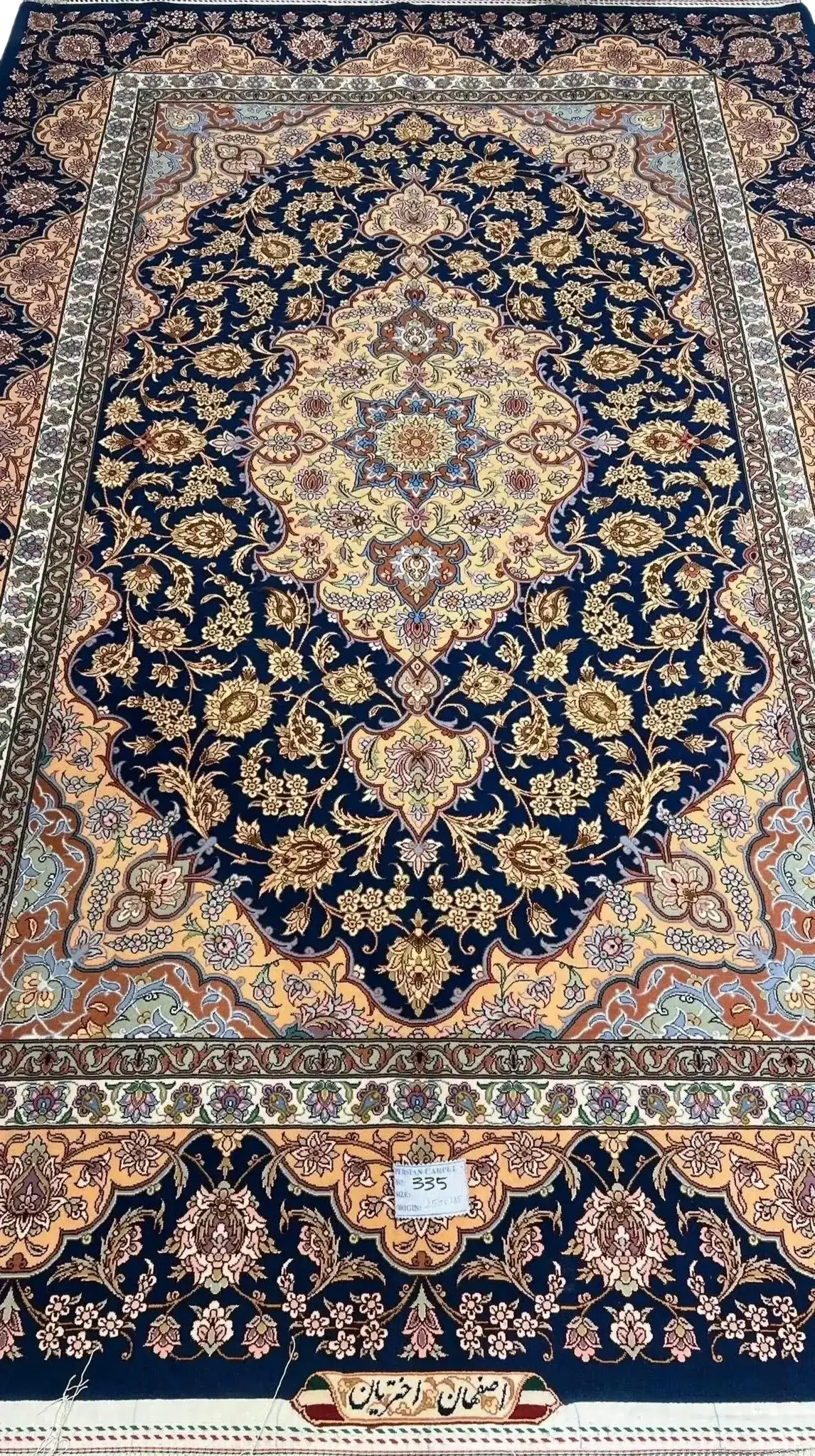 Hand-knotted navy blue and gold Persian rug with intricate floral patterns, 260x170 cm
