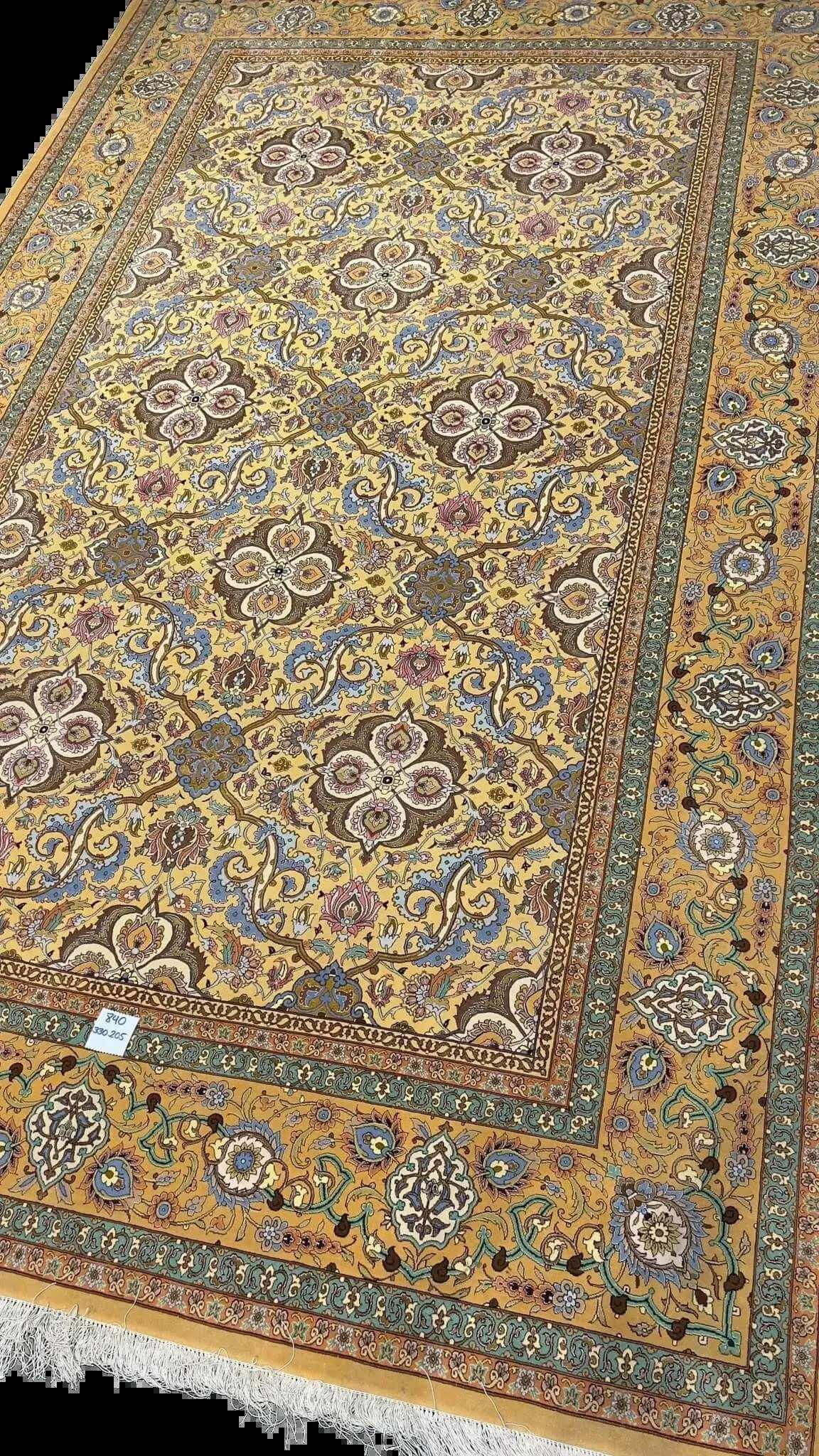 Master Weaver Haghieghie's wool and silk carpet featuring gold and blue motifs